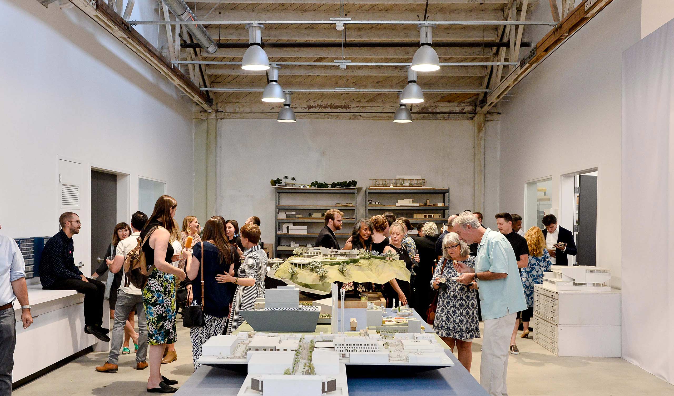 People in the RIOS makerspace looking at built models of RIOS projects