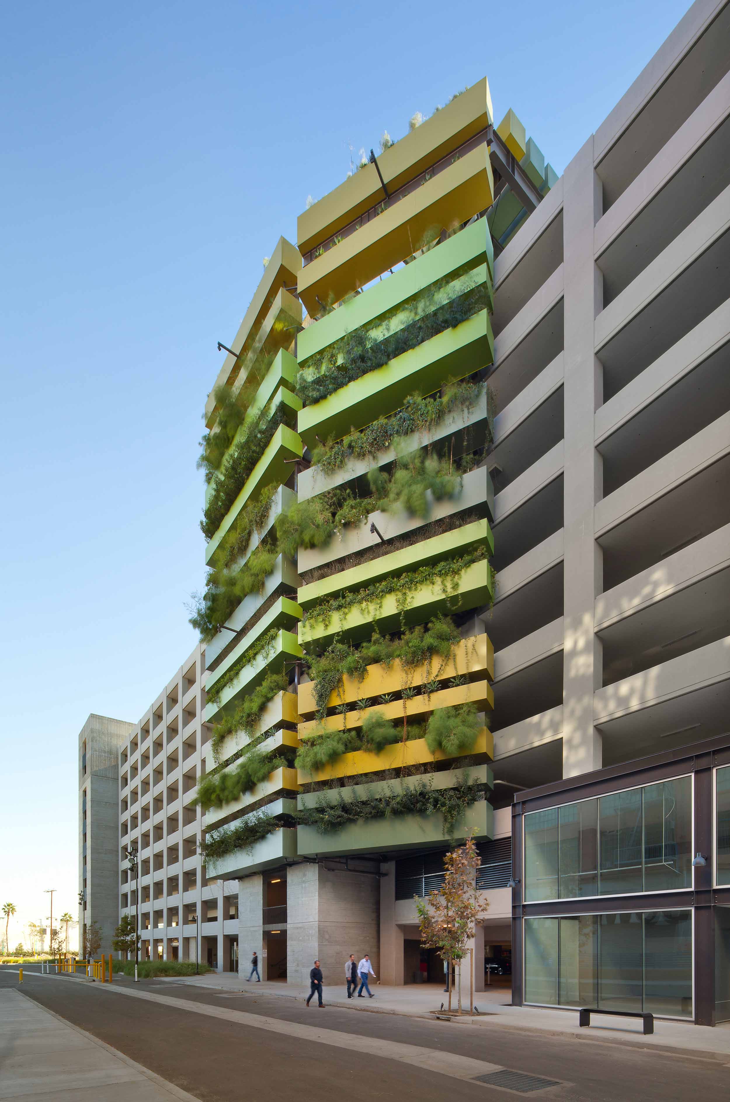 exterior shot of a garage with a green façade and plants cascading down