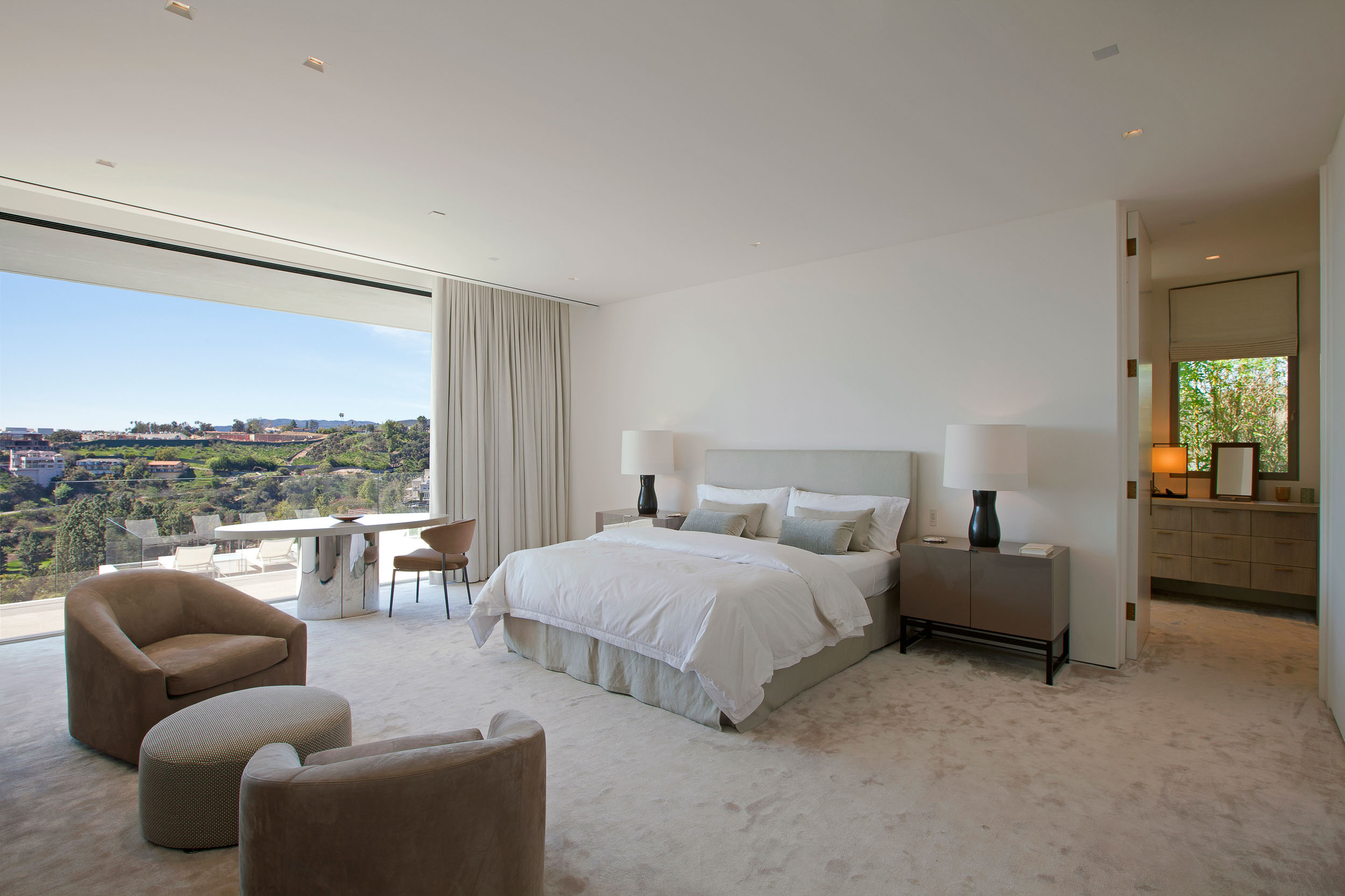 neutral master bedroom with large window