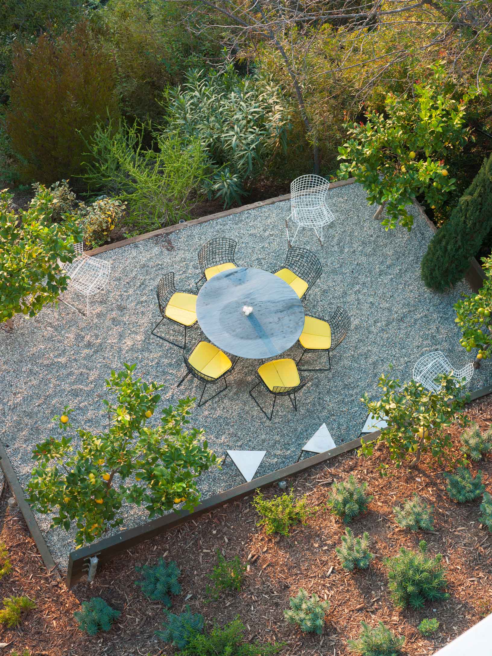 aerial view of circular table outdoors with yellow chairs