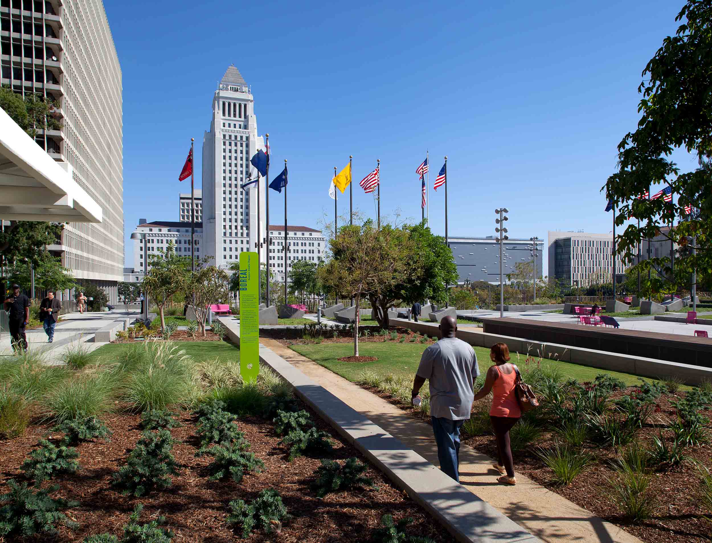 people walking a long a path toward city hall