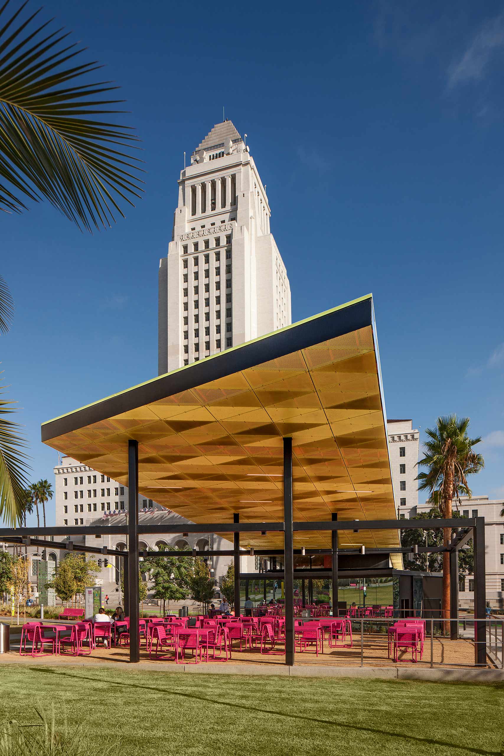 pink seating underneath a pergola in front of city hall