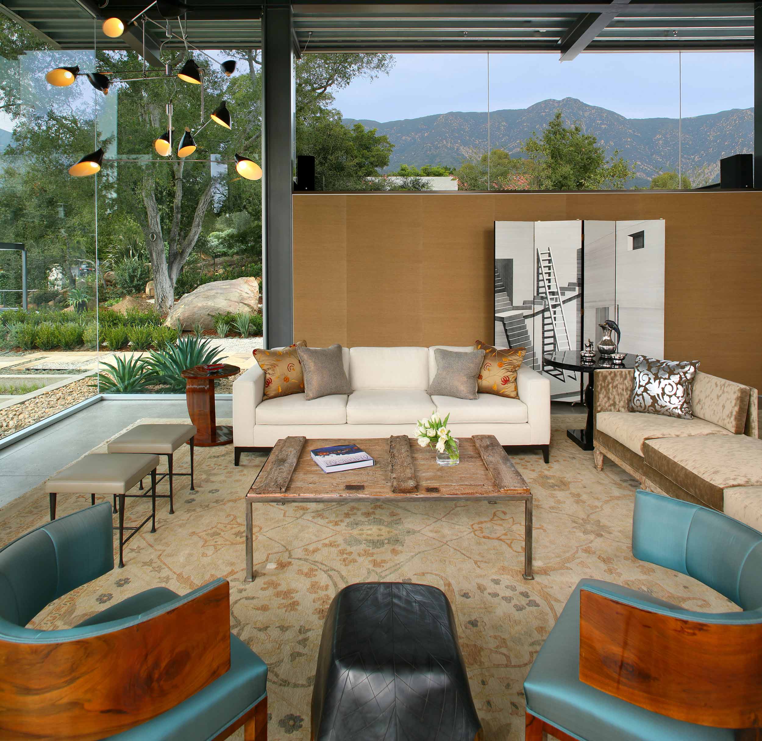 living area with glass walls and rustic wood coffee table