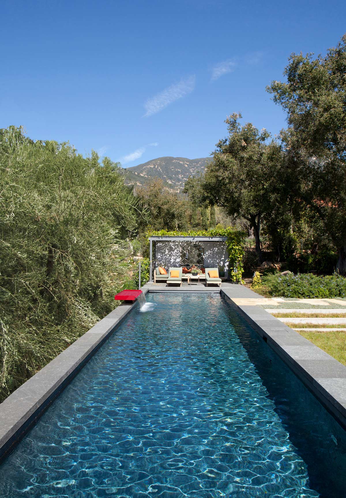 long pool with bungalow and lounge chairs