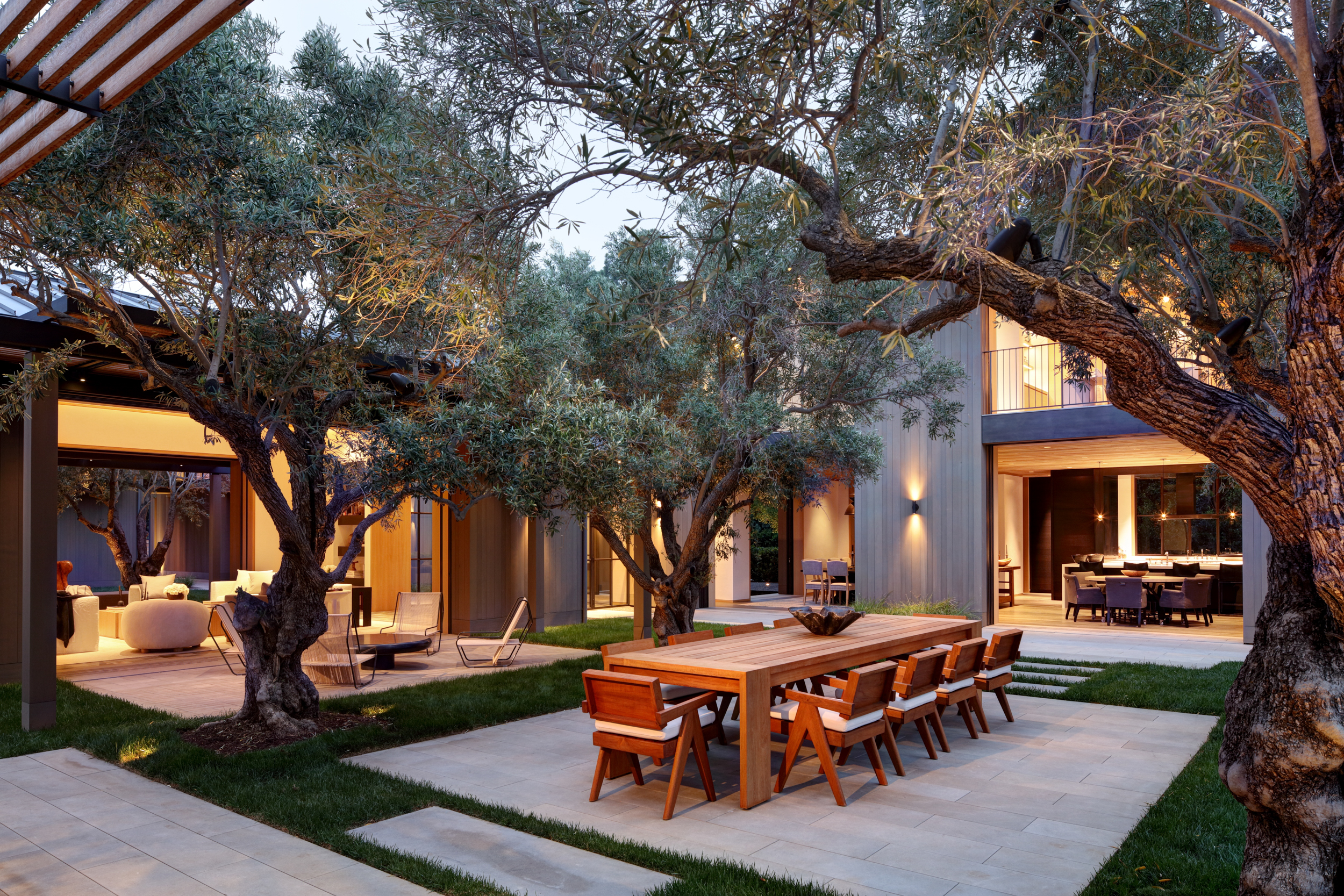 modern residential courtyard with pavers and olive trees