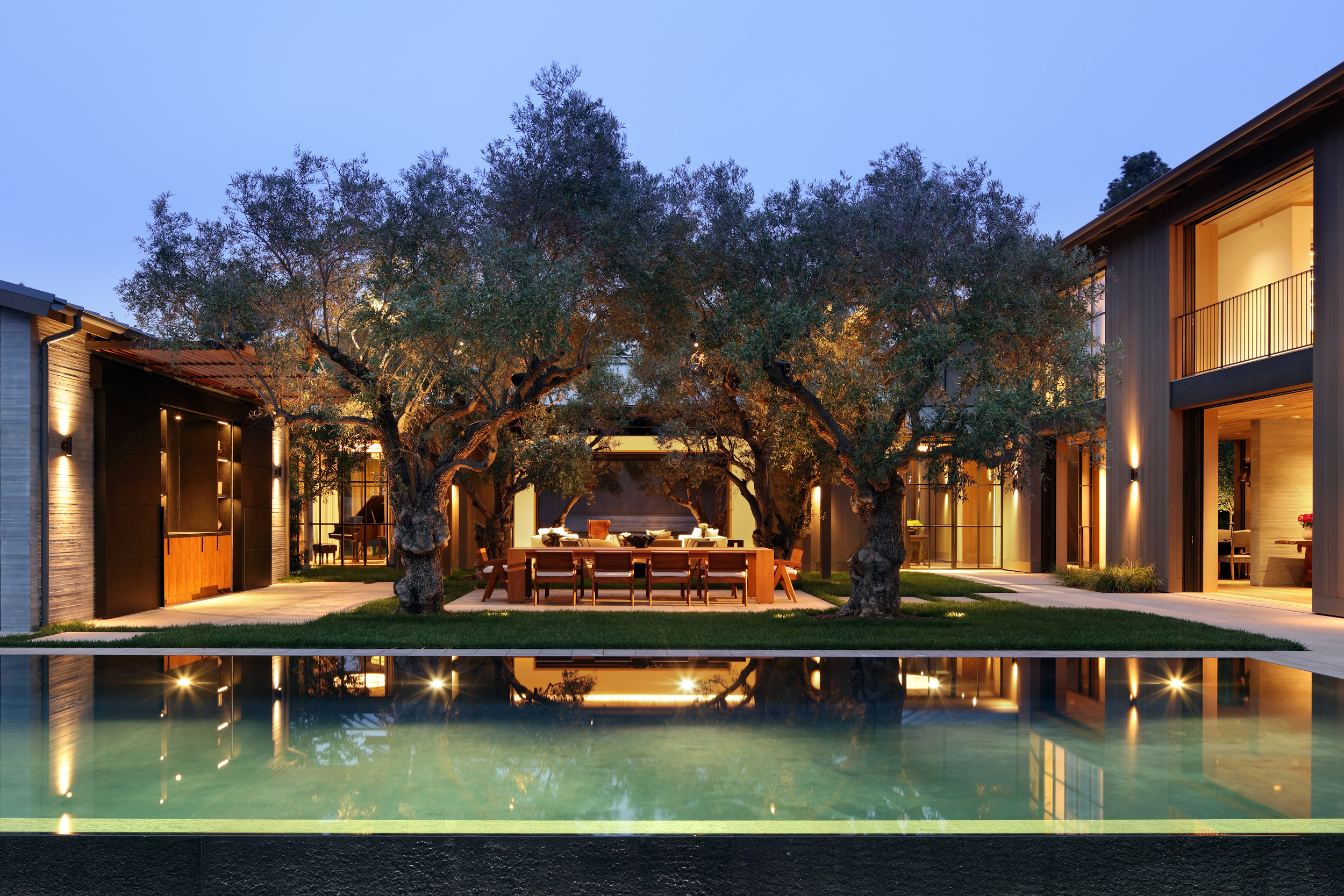 infinity pool in courtyard with olive trees