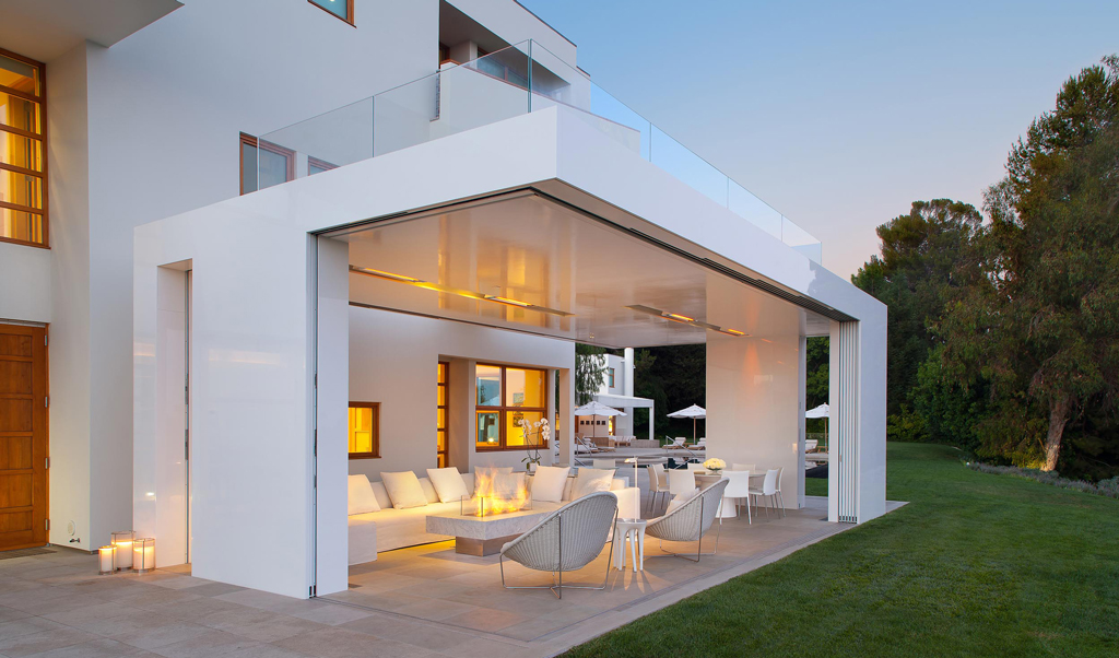 Home in the evening with sliding doors that open up to the outside