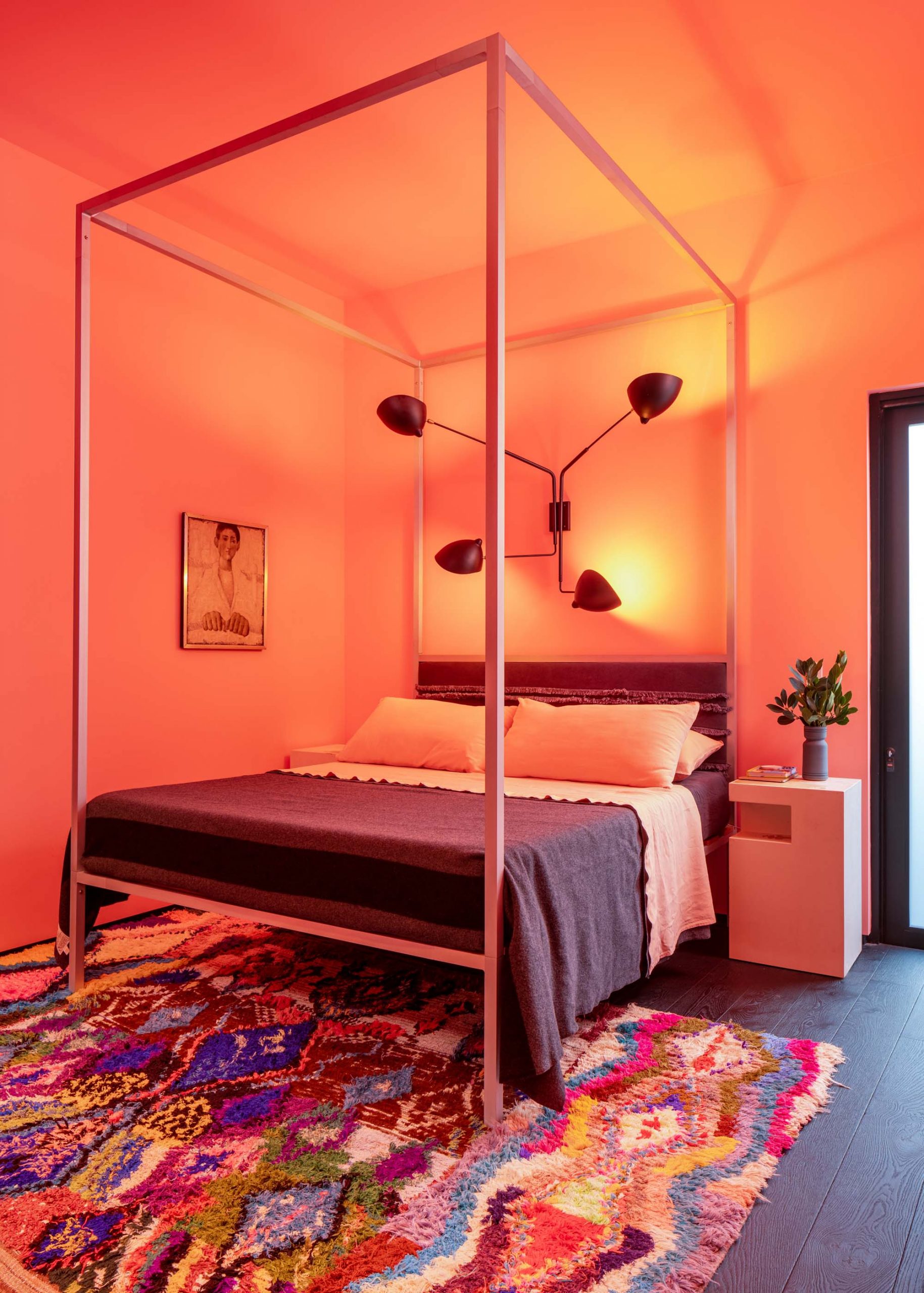 architectural poster bed with pink walls and patterned rug