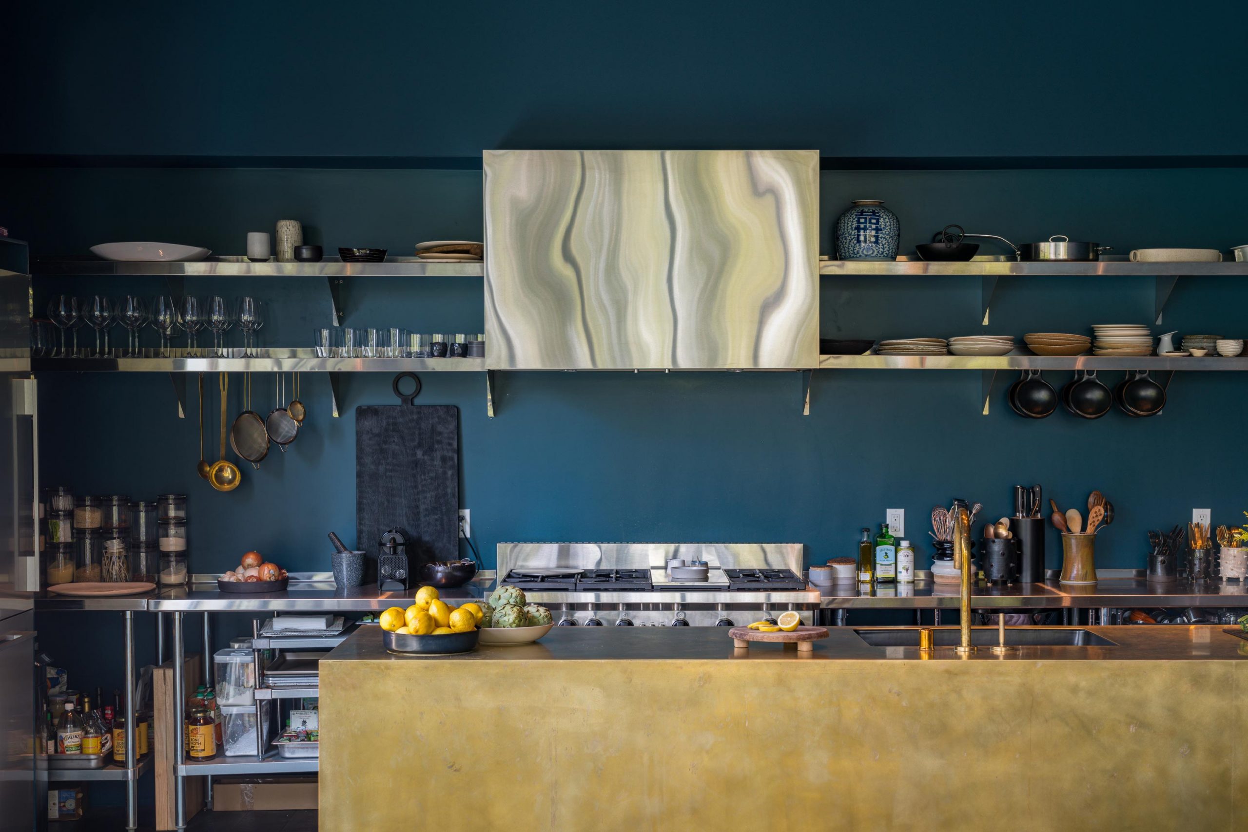 modern kitchen with deep blue wall and open shelves