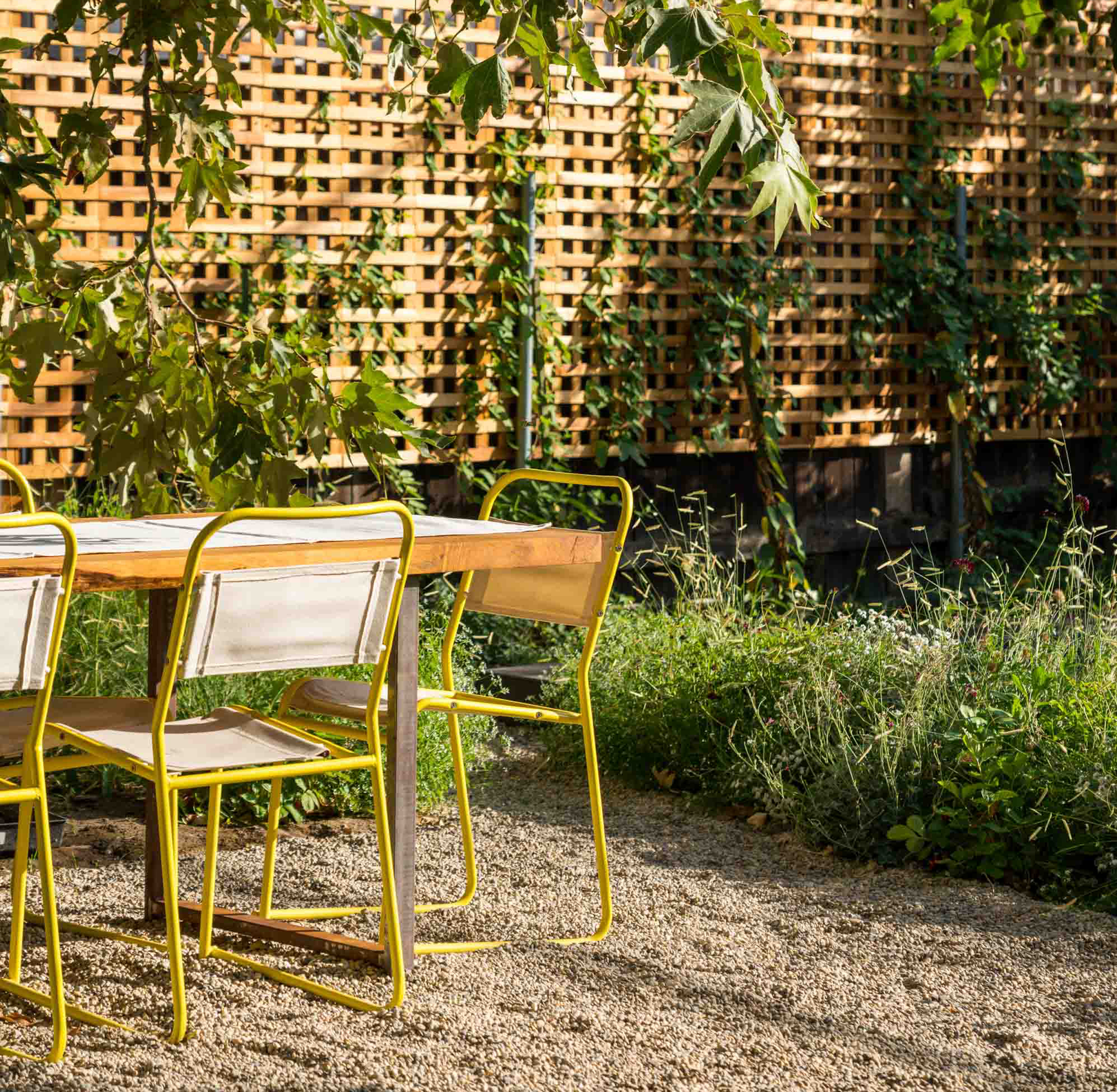 outdoor table with yellow metal chairs