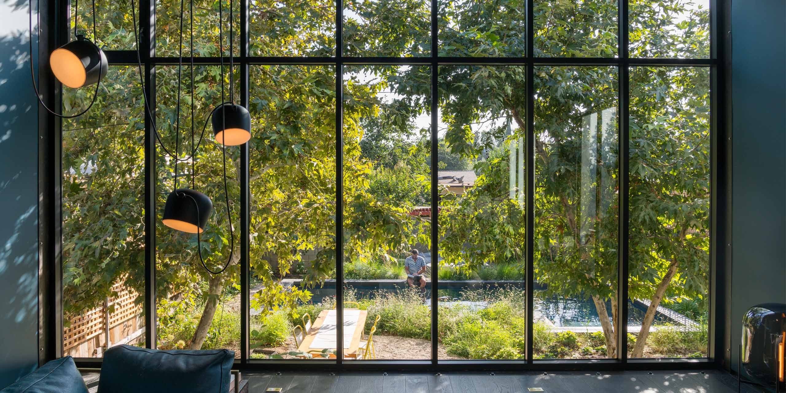 view through large window with hanging light fixture