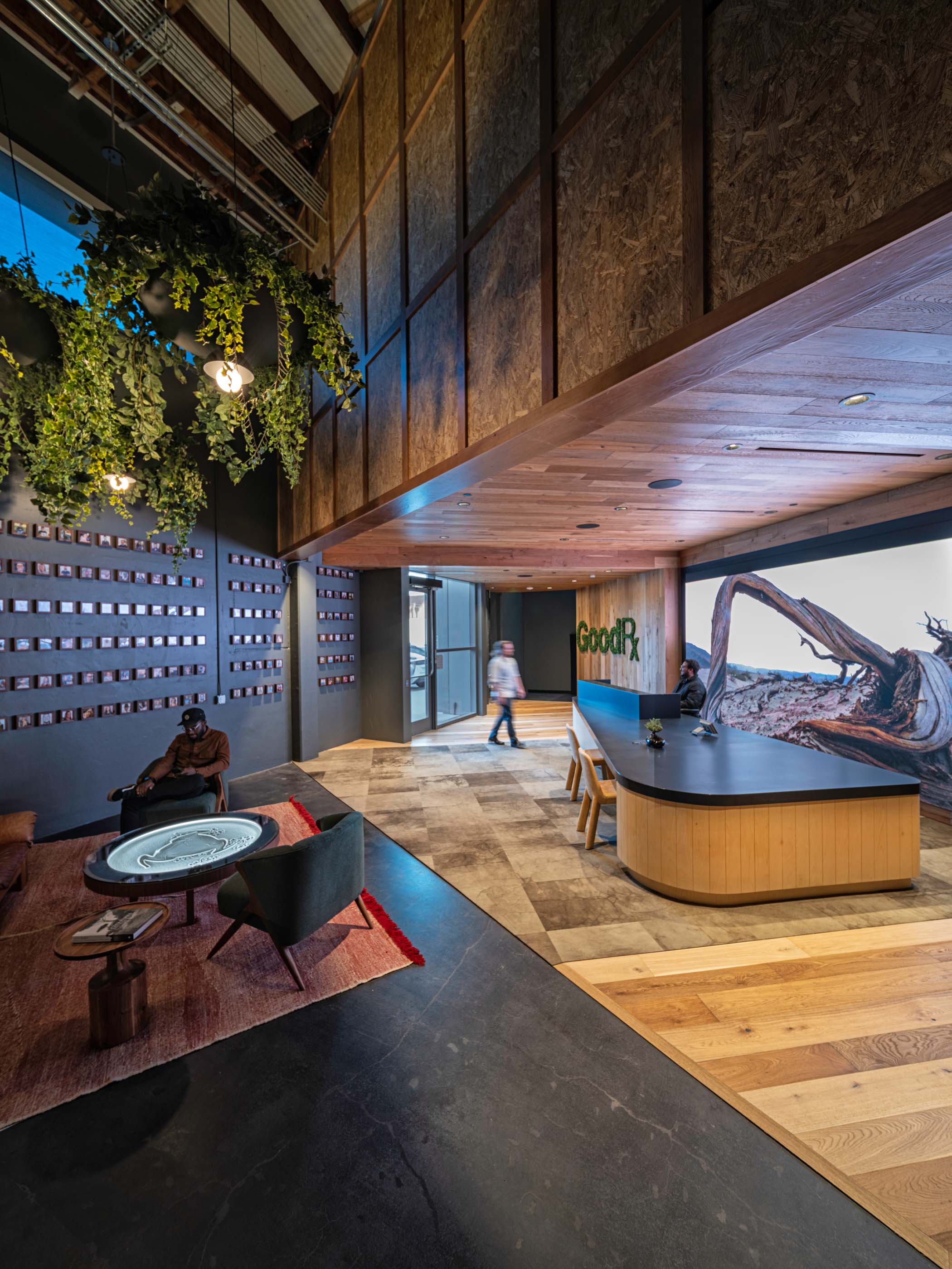 Good Rx lobby entrance with a front desk, a table, and wood finishes