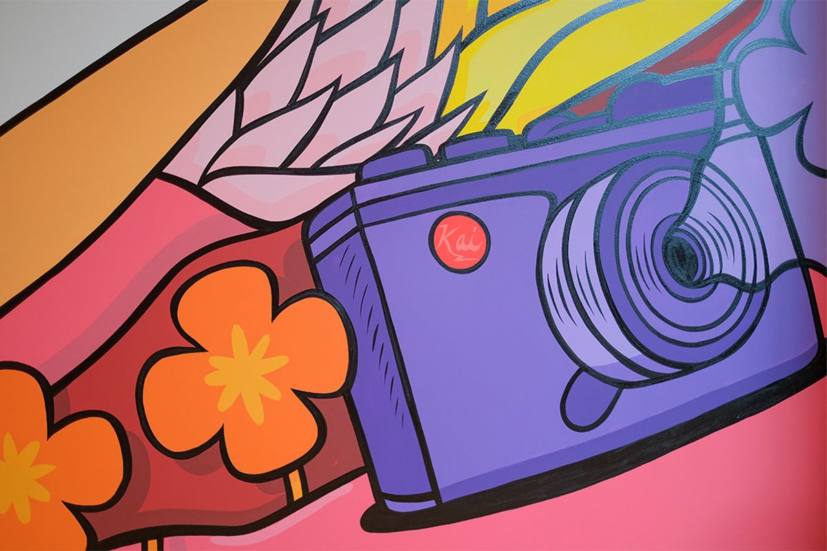 close up shot of a purple camera on a colorful mural