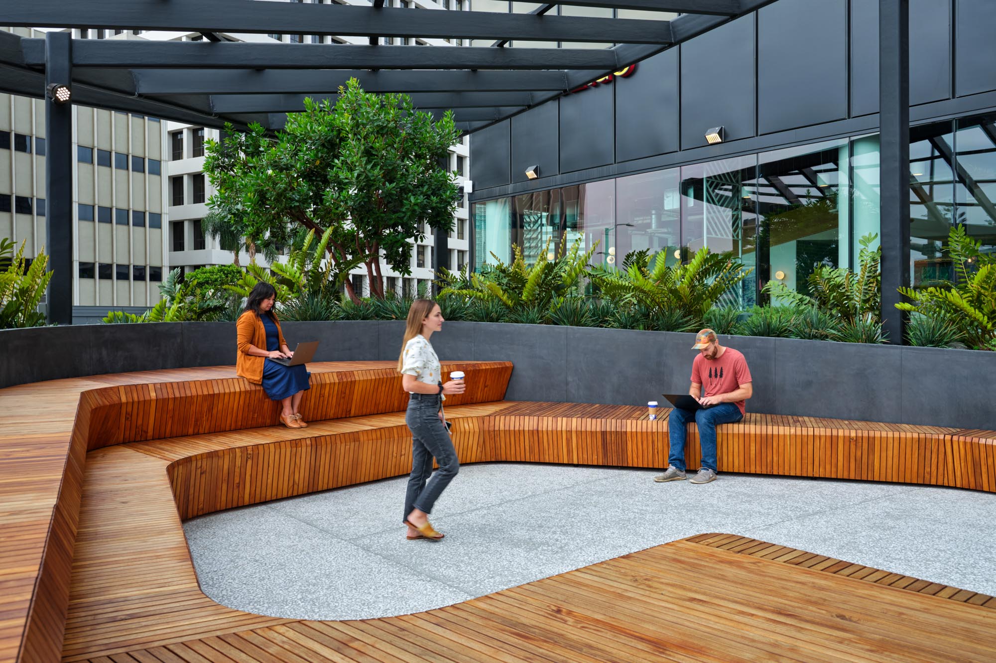 People sitting on a tiered wooden bench