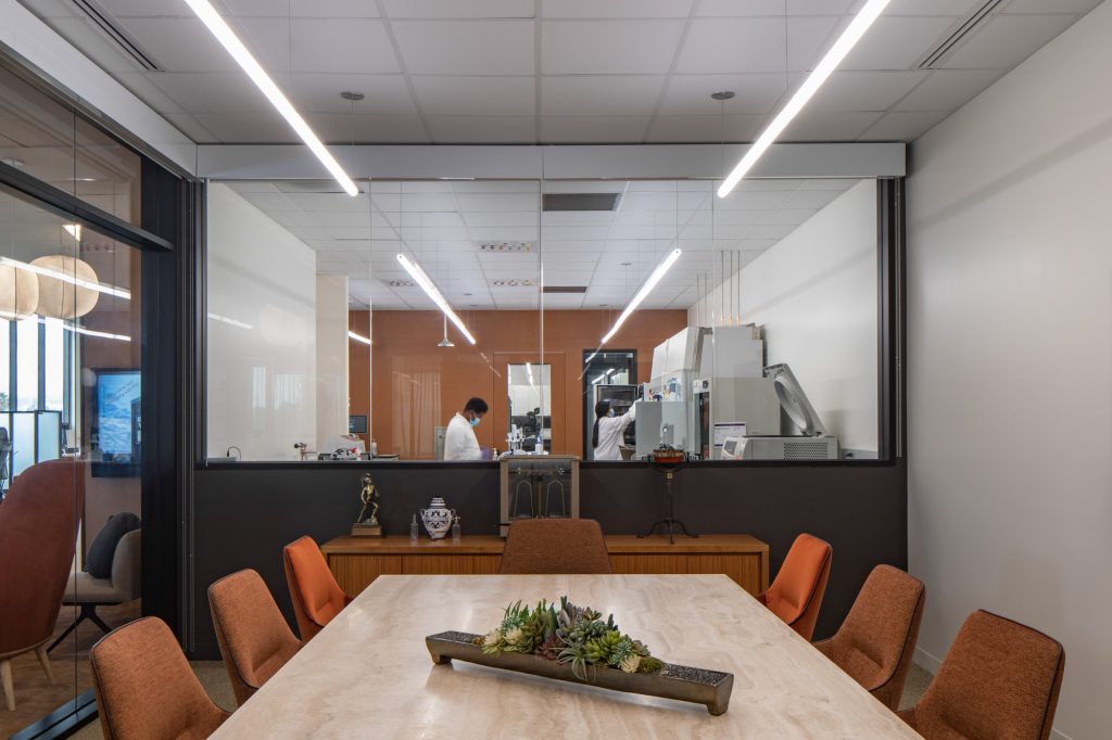 Conference room looking into the laboratory with glass windows