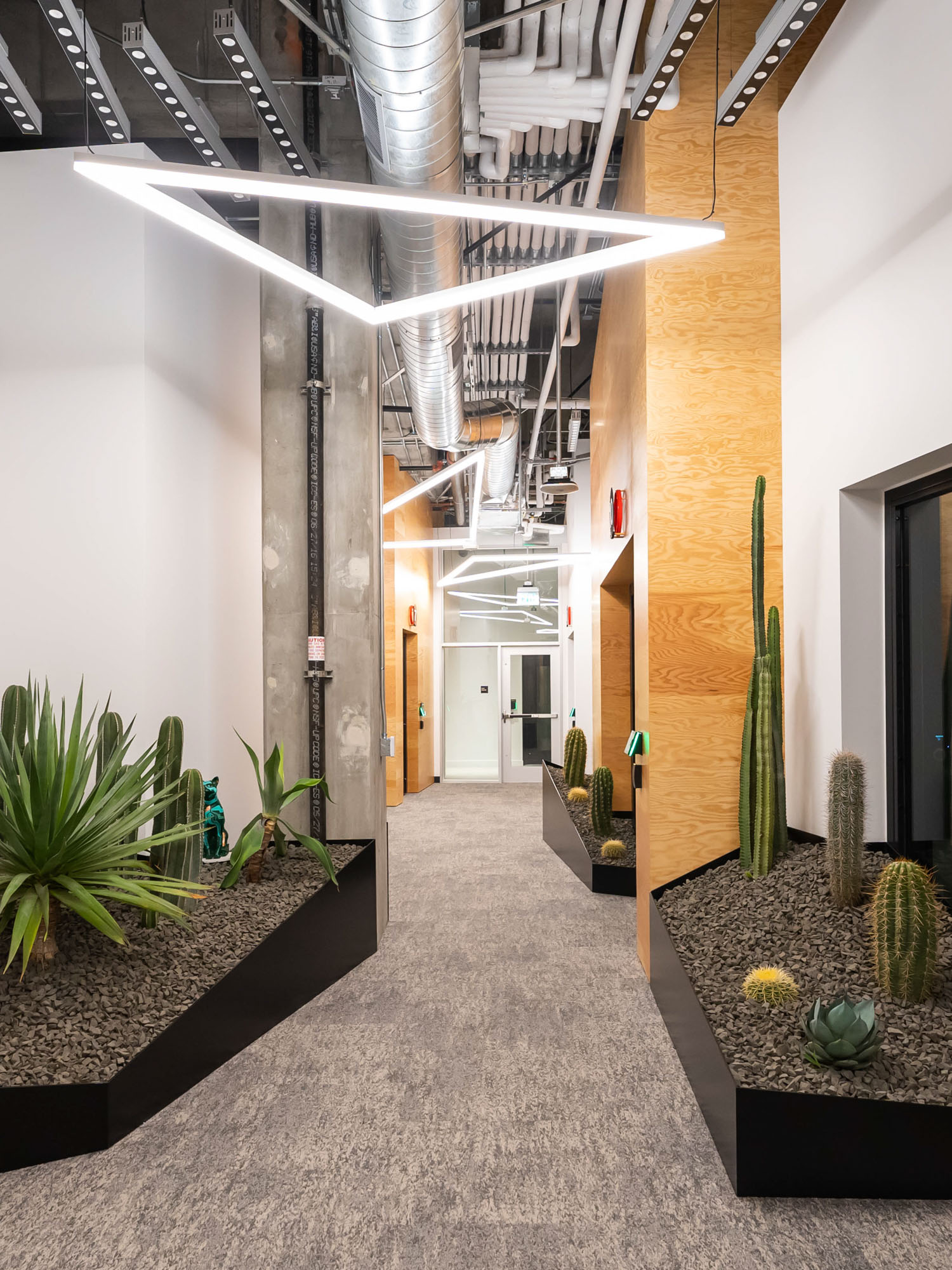 pod city hallway lined with planters and interior landscaping