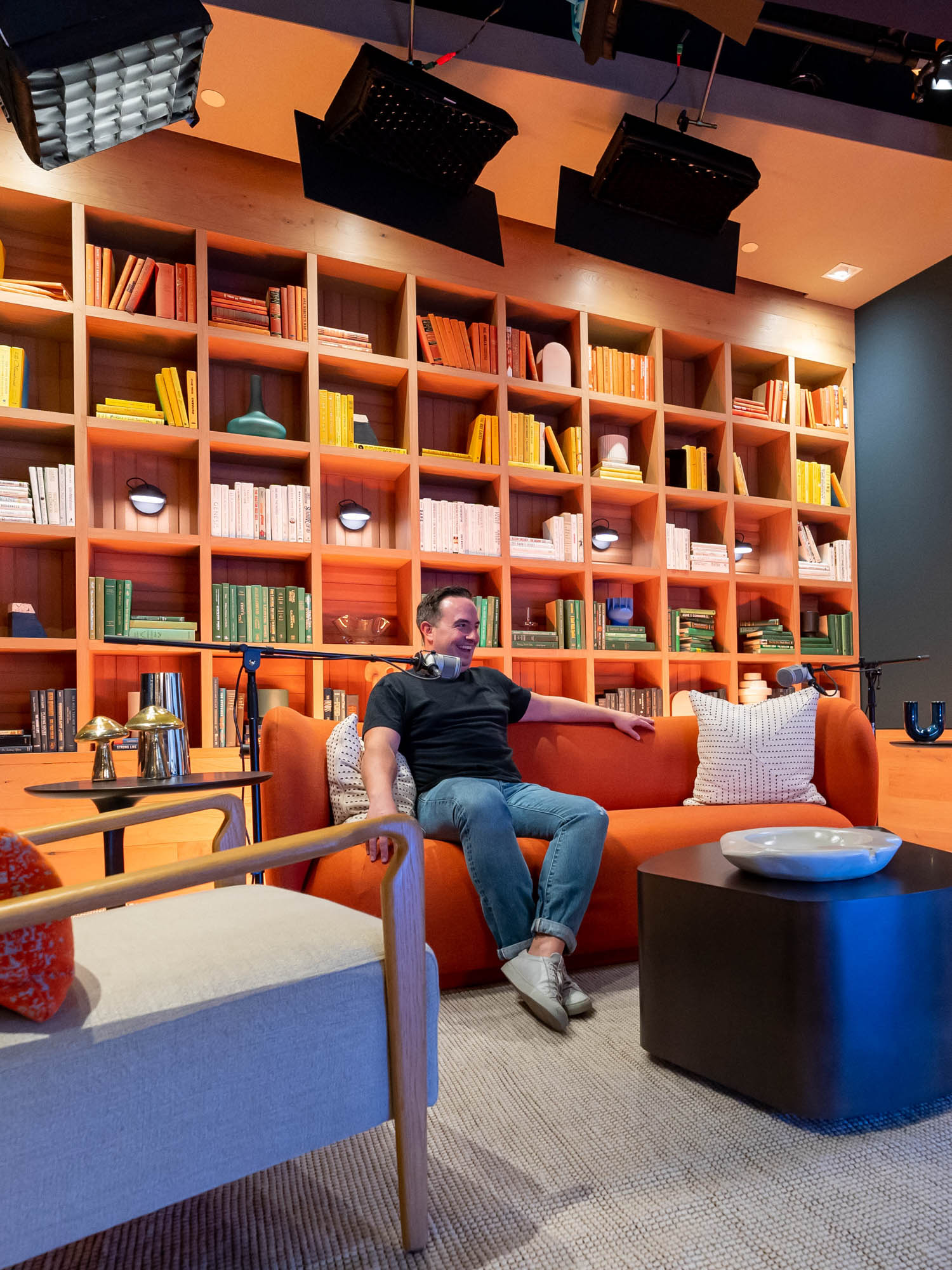 man sitting in the pod city recording room with colorful furniture