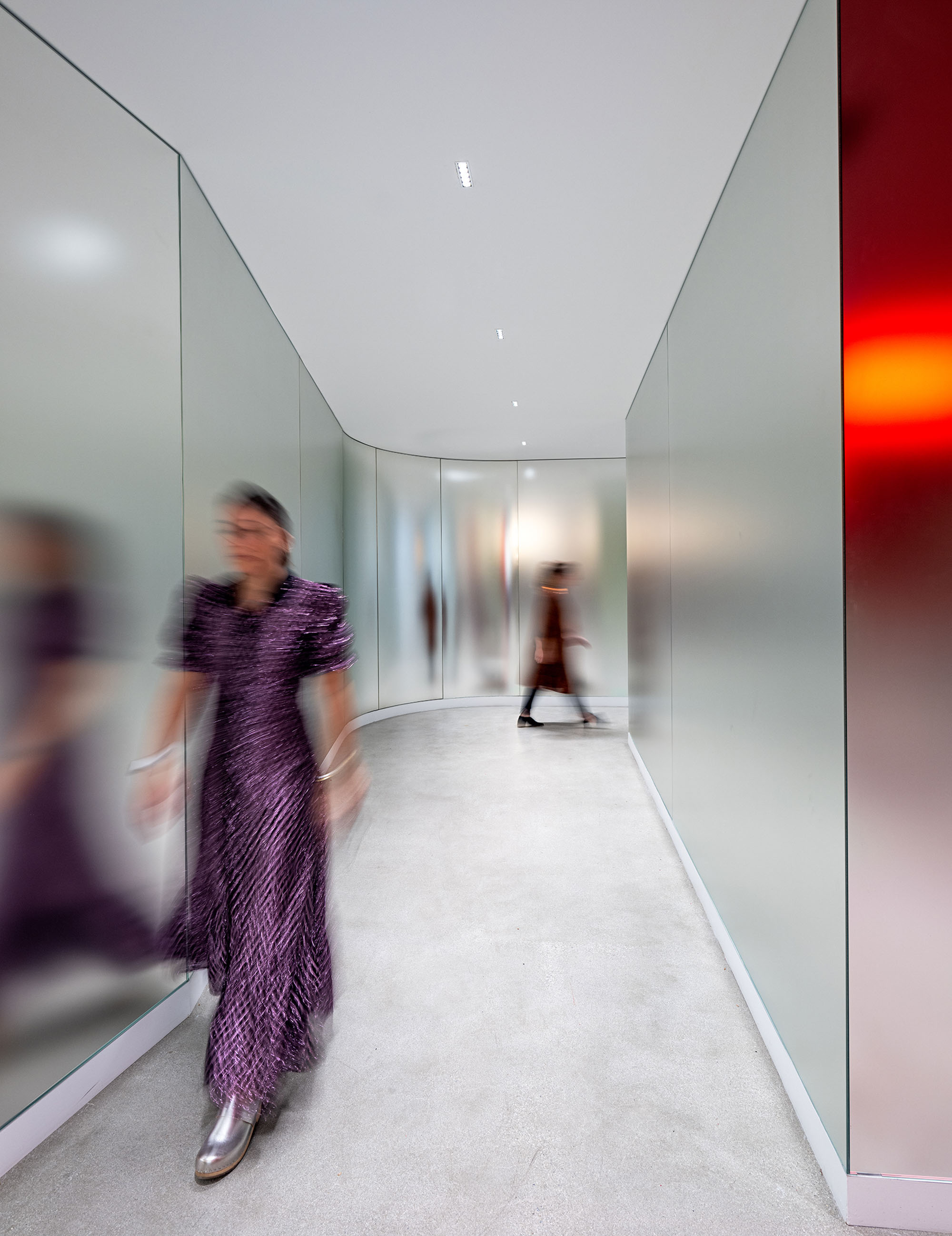 Woman walking through minimalist hallway