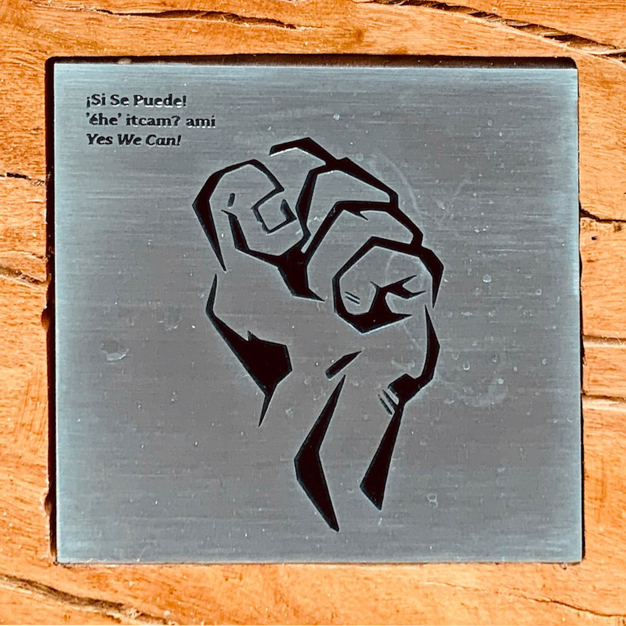 Fist printed on metal inlayed in wood