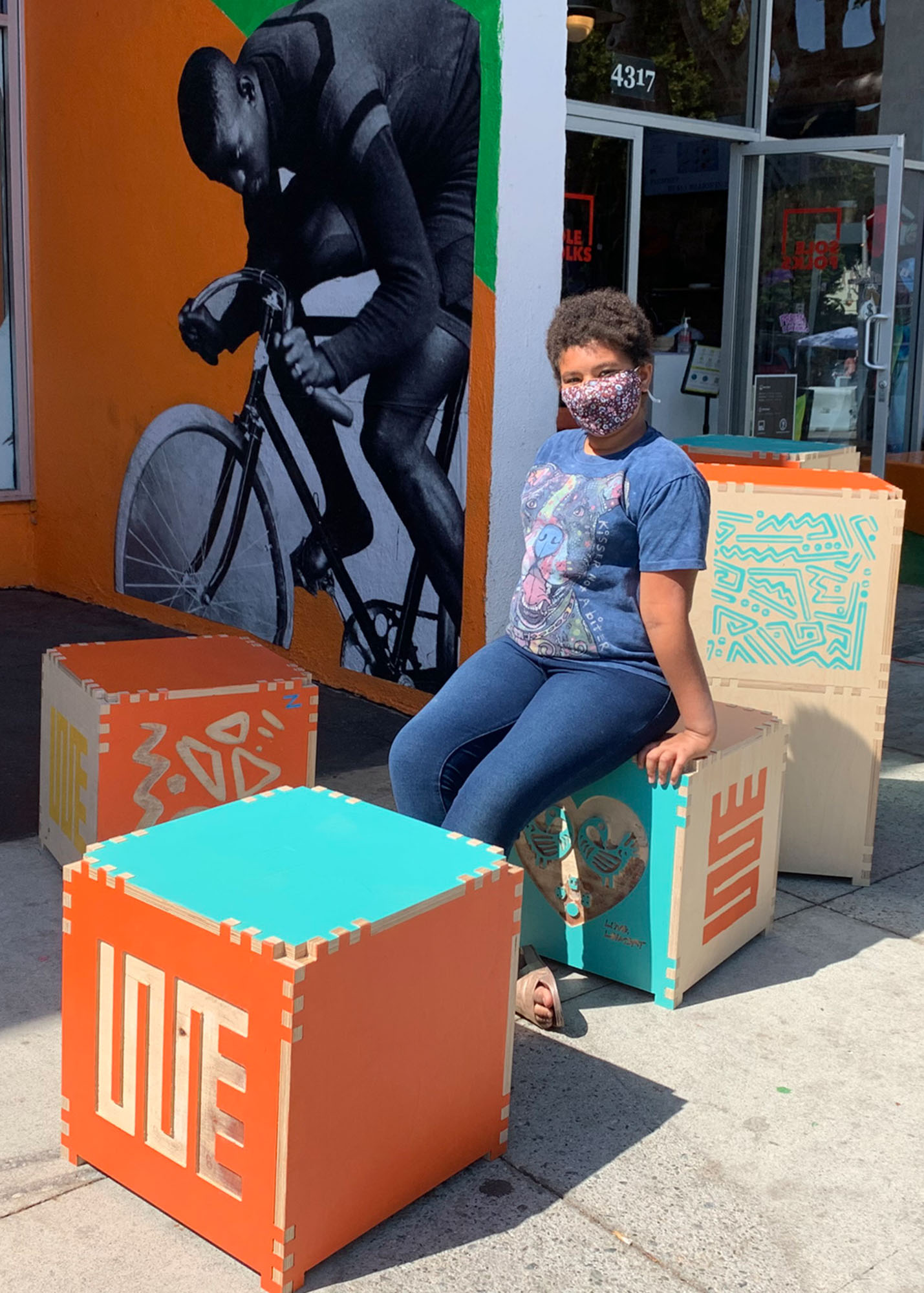 girl sitting on a cube with cubes surrounding her