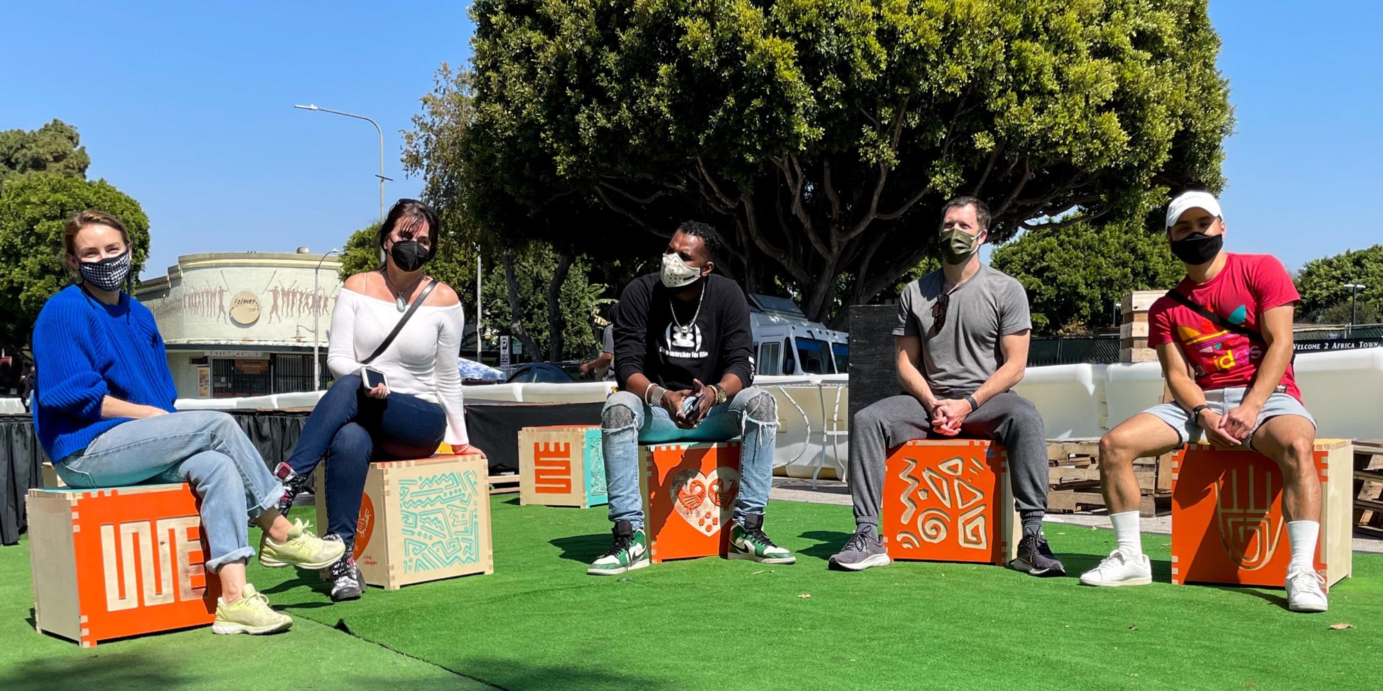 People sitting on colorful wooden cubes