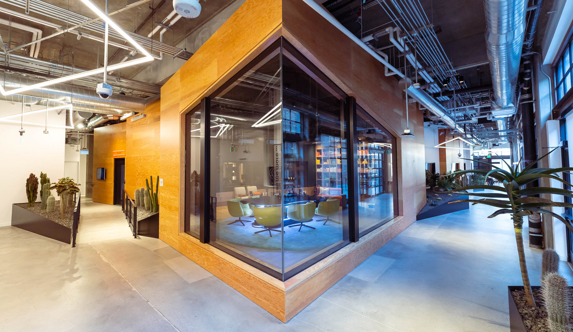 hallway and enclosed glass room with plants