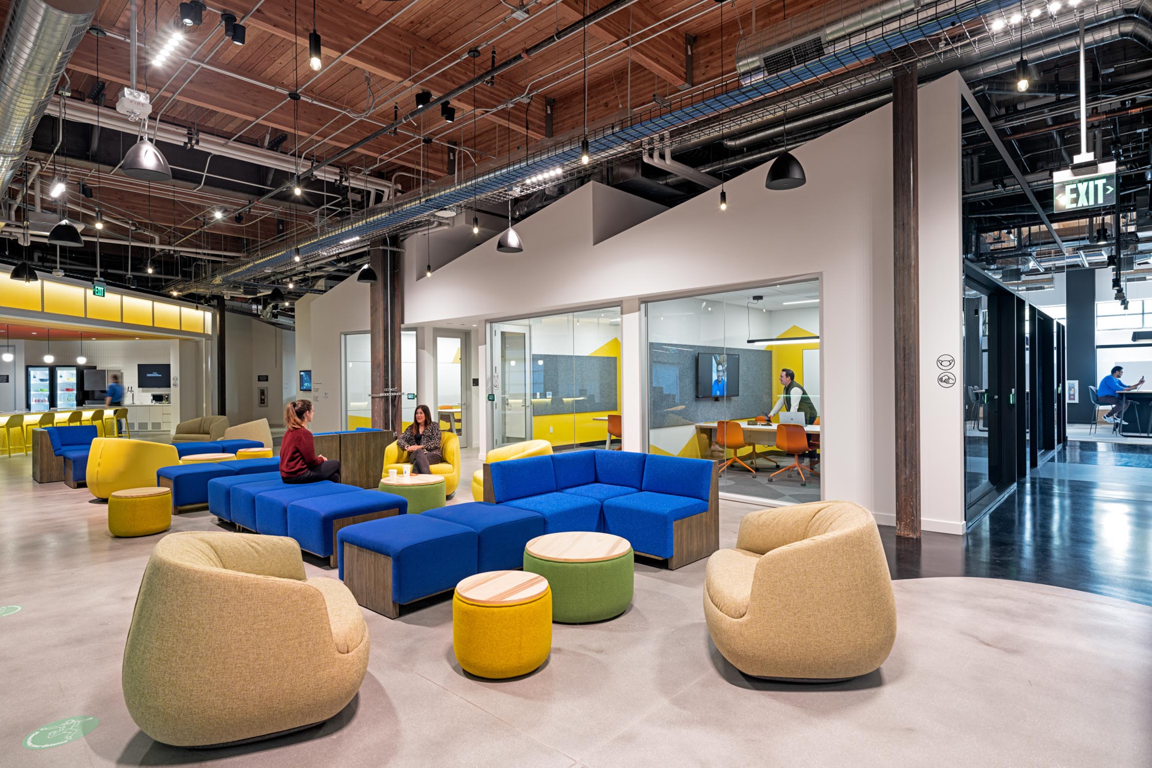 Lounge spaces outside of conference rooms with comfortable and colorful couches