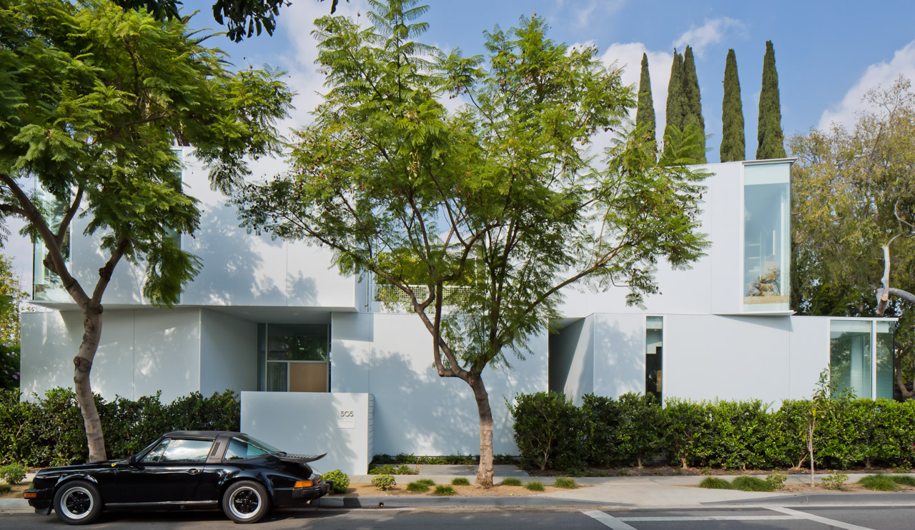 Street view of small private residence tucked behind streets