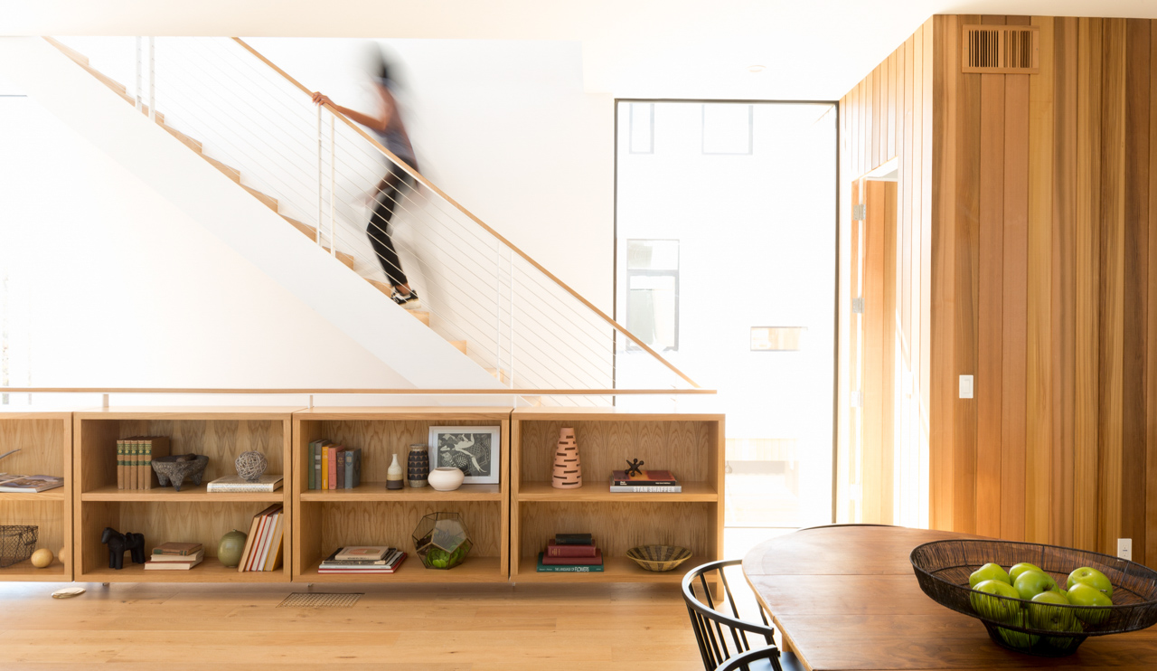 Interiors of small home with blurry woman walking up stairs