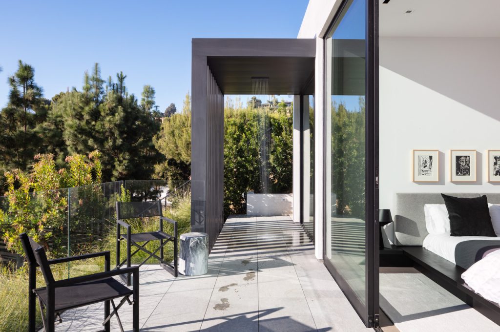 Outdoor shower with open slider connecting to the interior