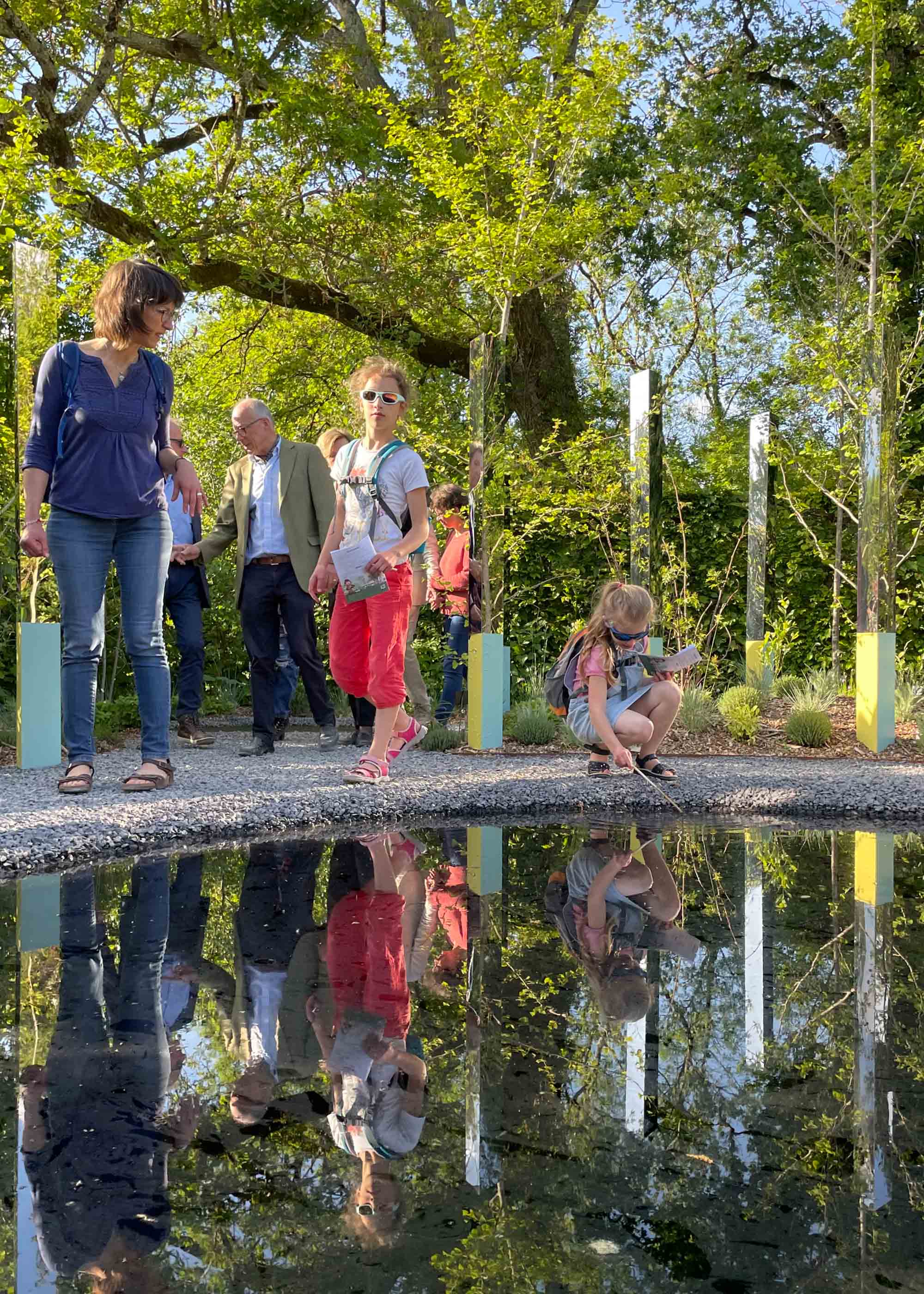 Family looking in a reflecting pond at the Garden of Reciprocity