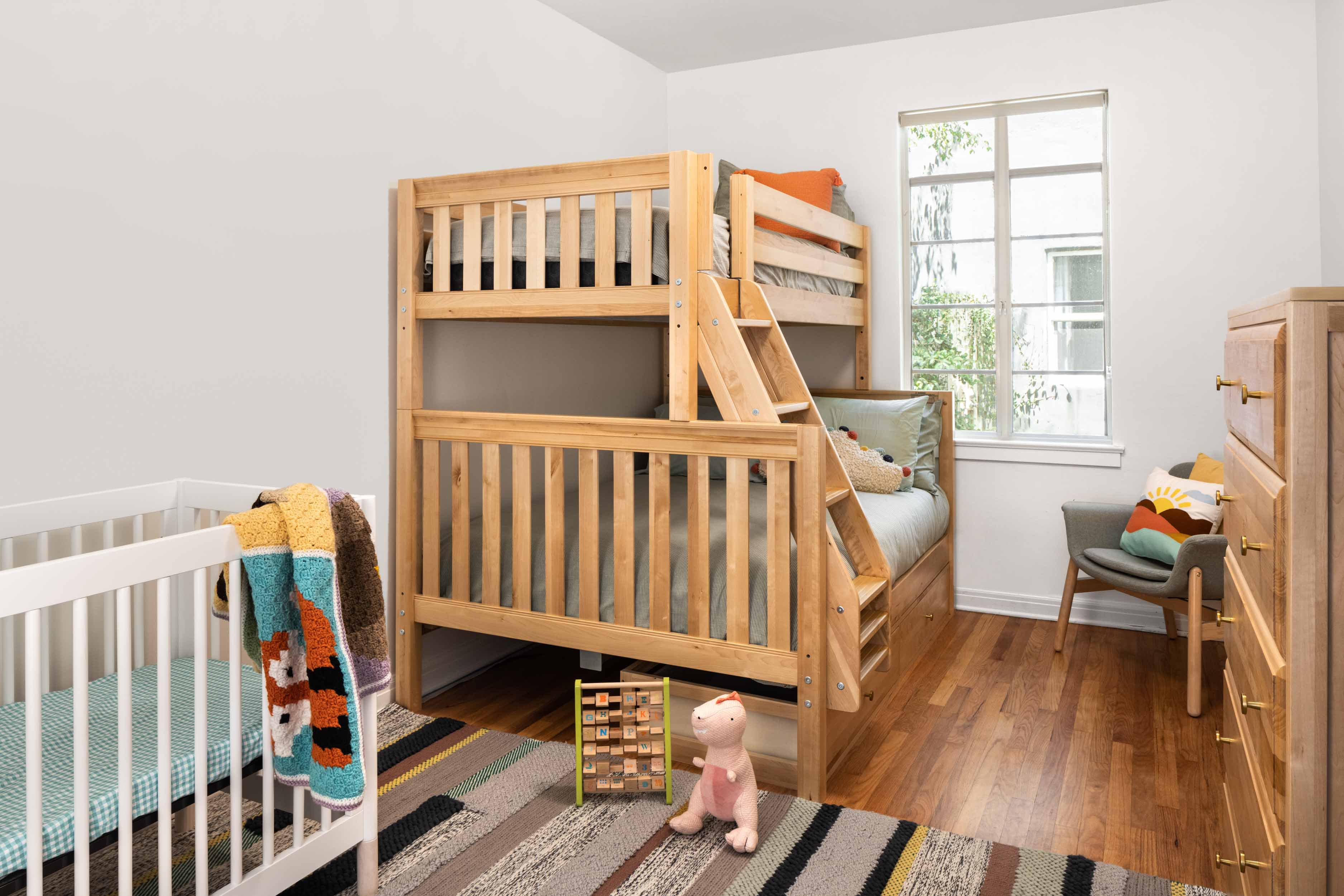 Children's bedroom with bunk bed, chair, and chest of drawers in neutral tones