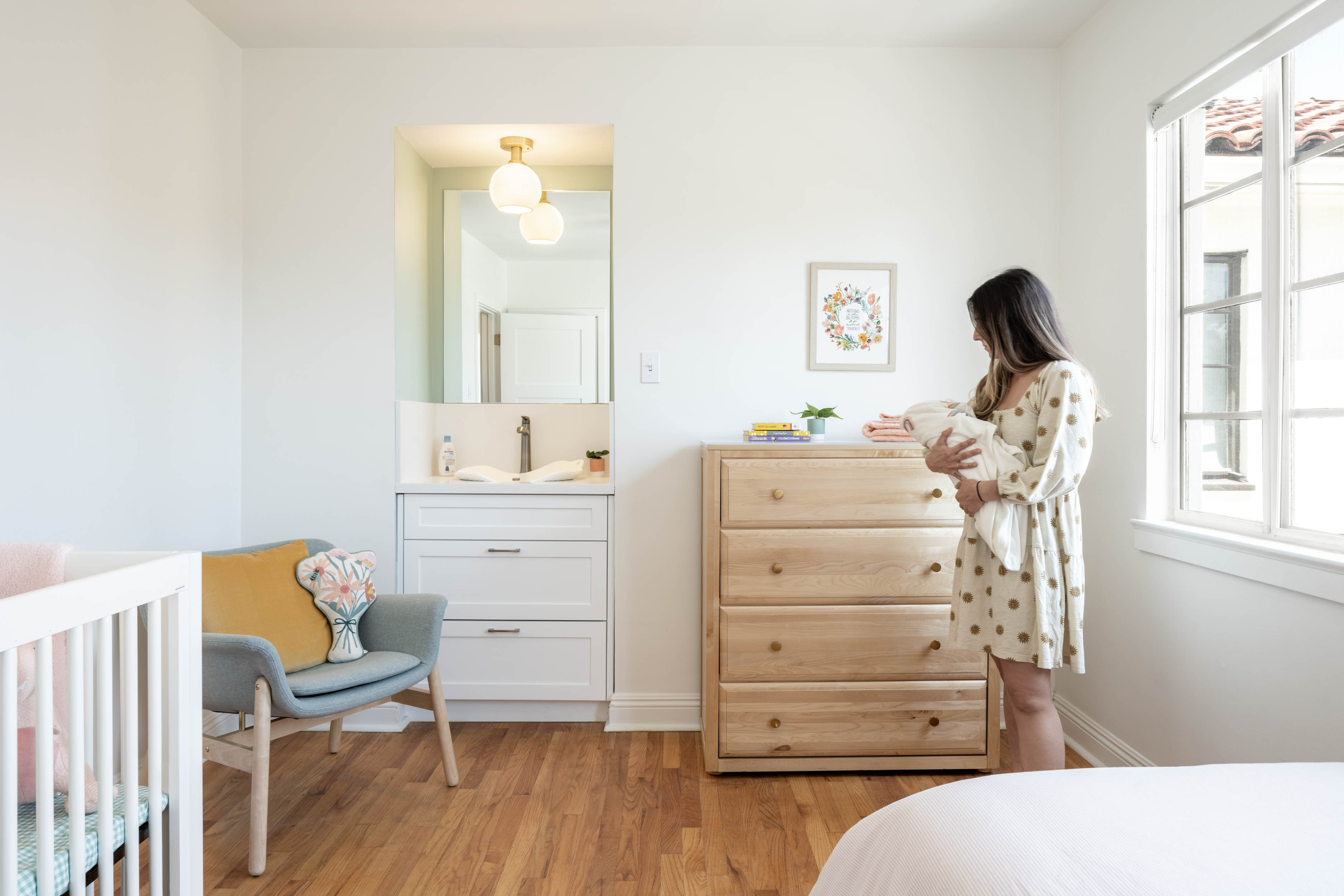 Mother holding baby in bedroom