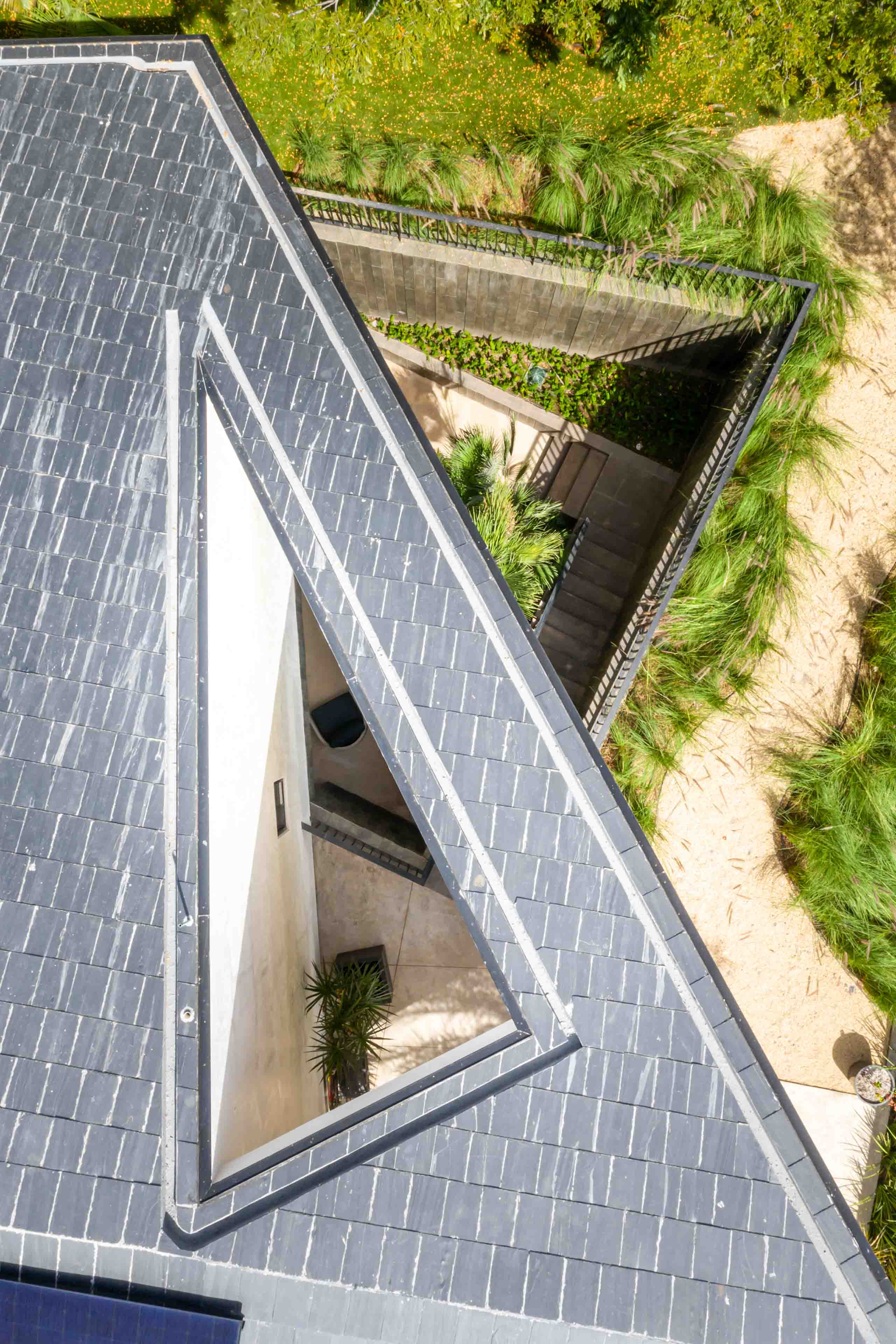 Aerial view of sunken courtyard at entry of home