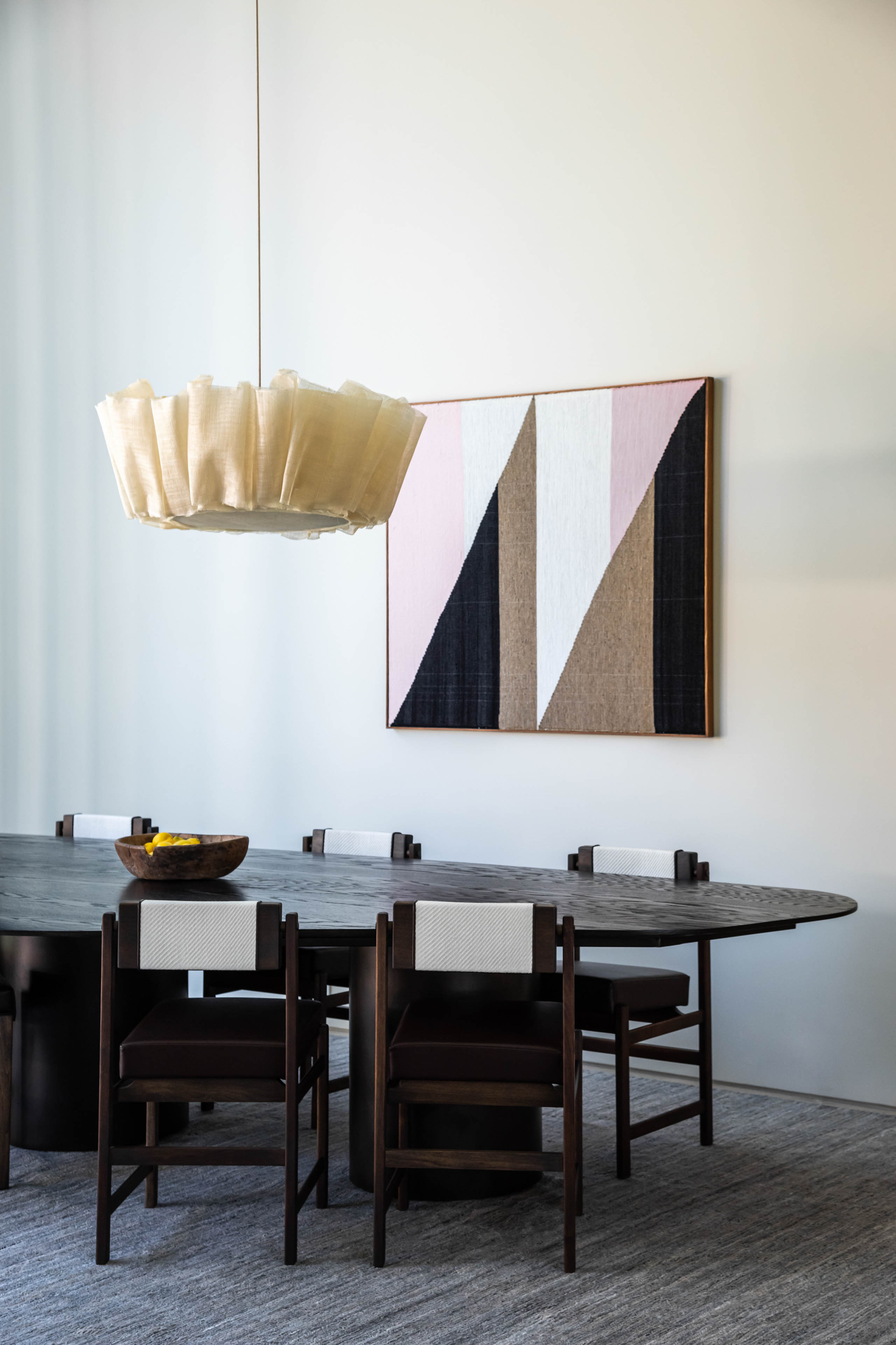 Curated living space with dining table and geometric artwork