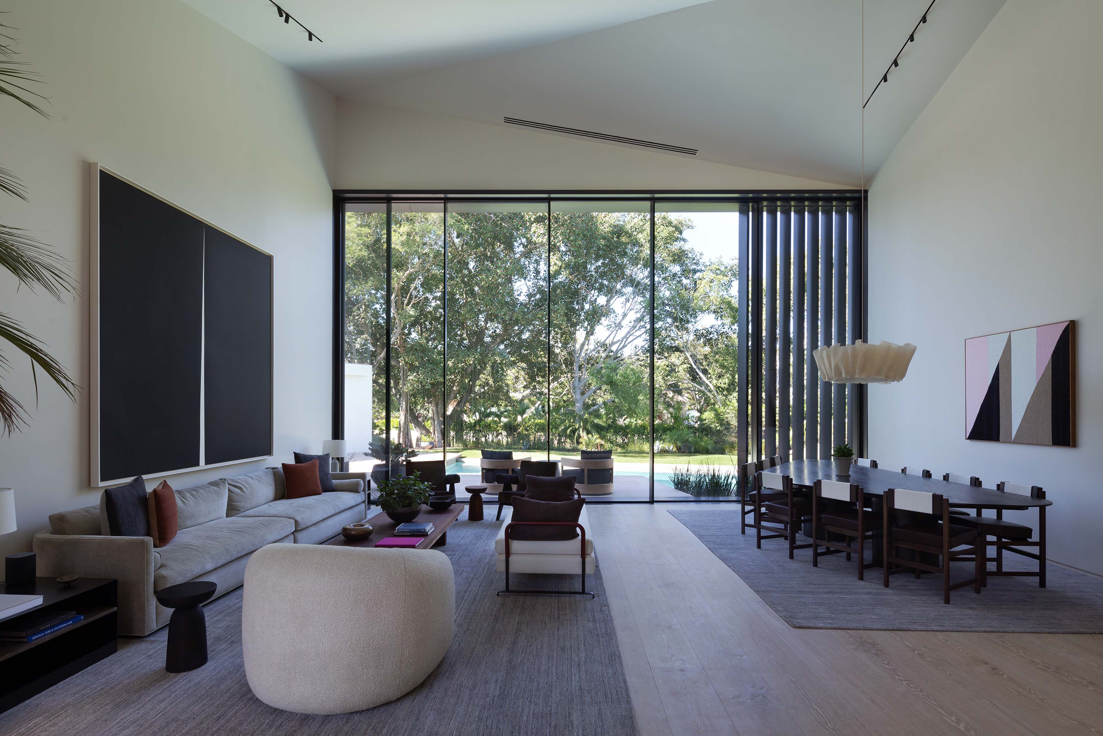 living room with comfortable and neutral interiors and large floor-to-ceiling windows