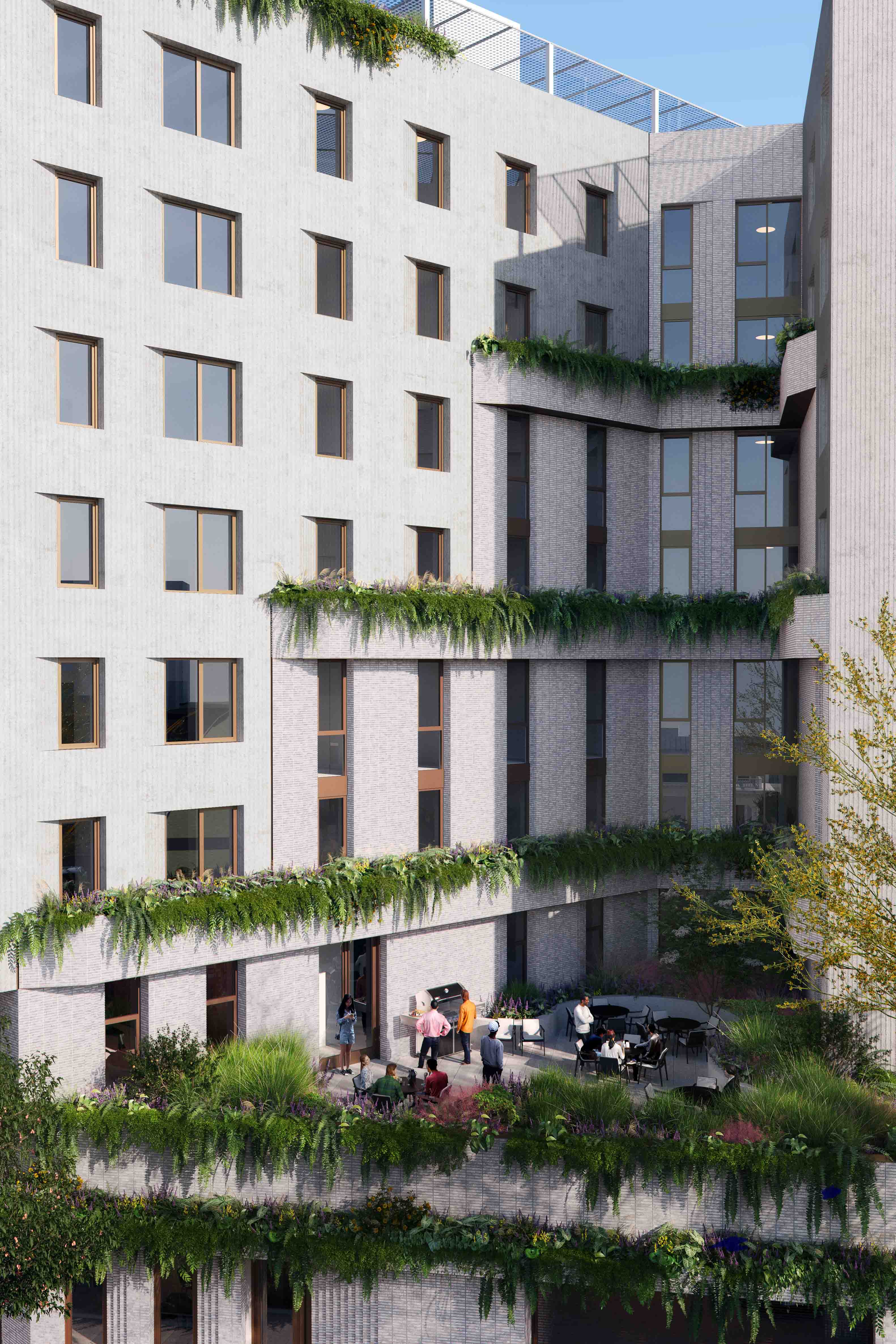 closeup of the building facade with green plantings alongside the building