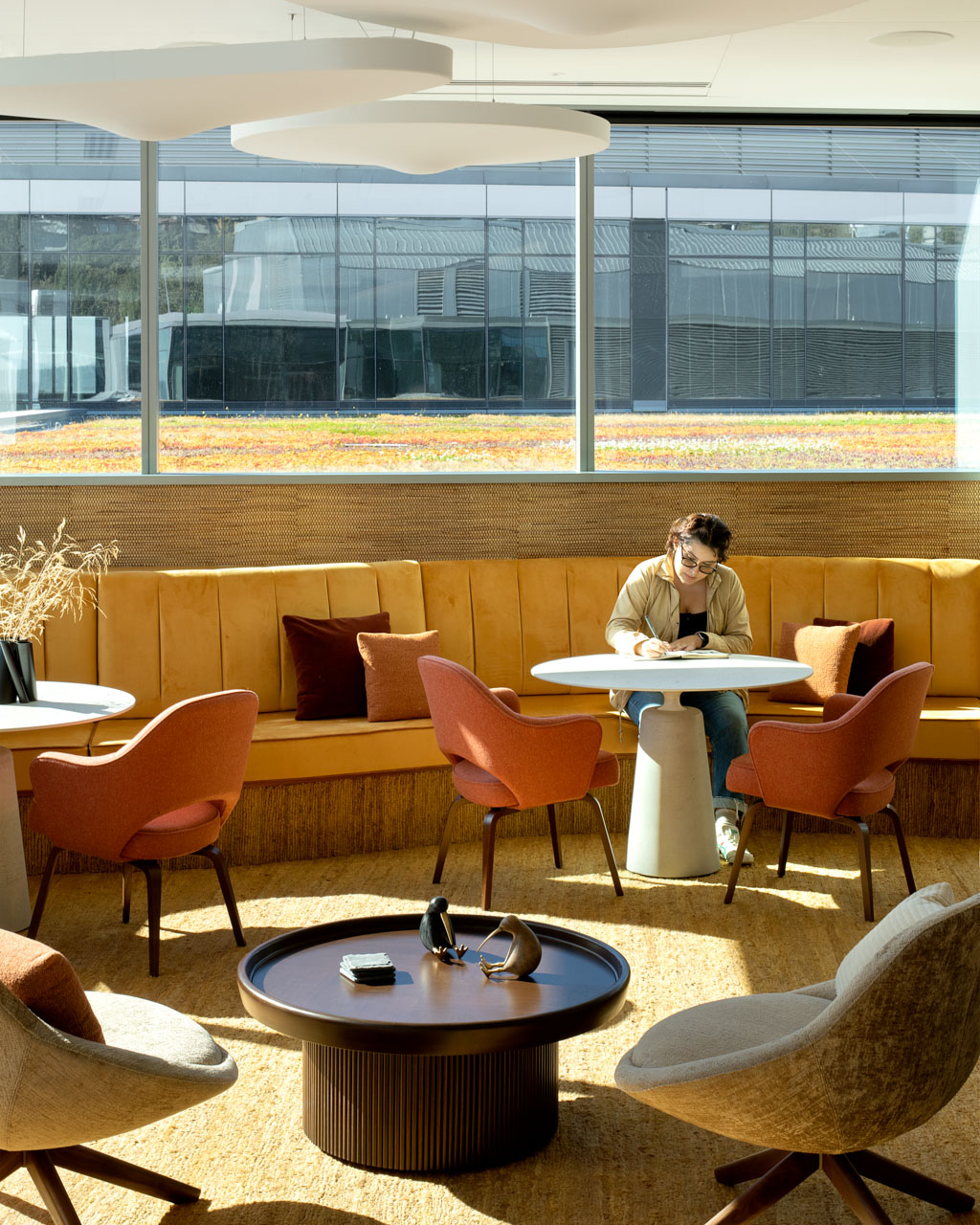 A woman sitting at a table in the office.