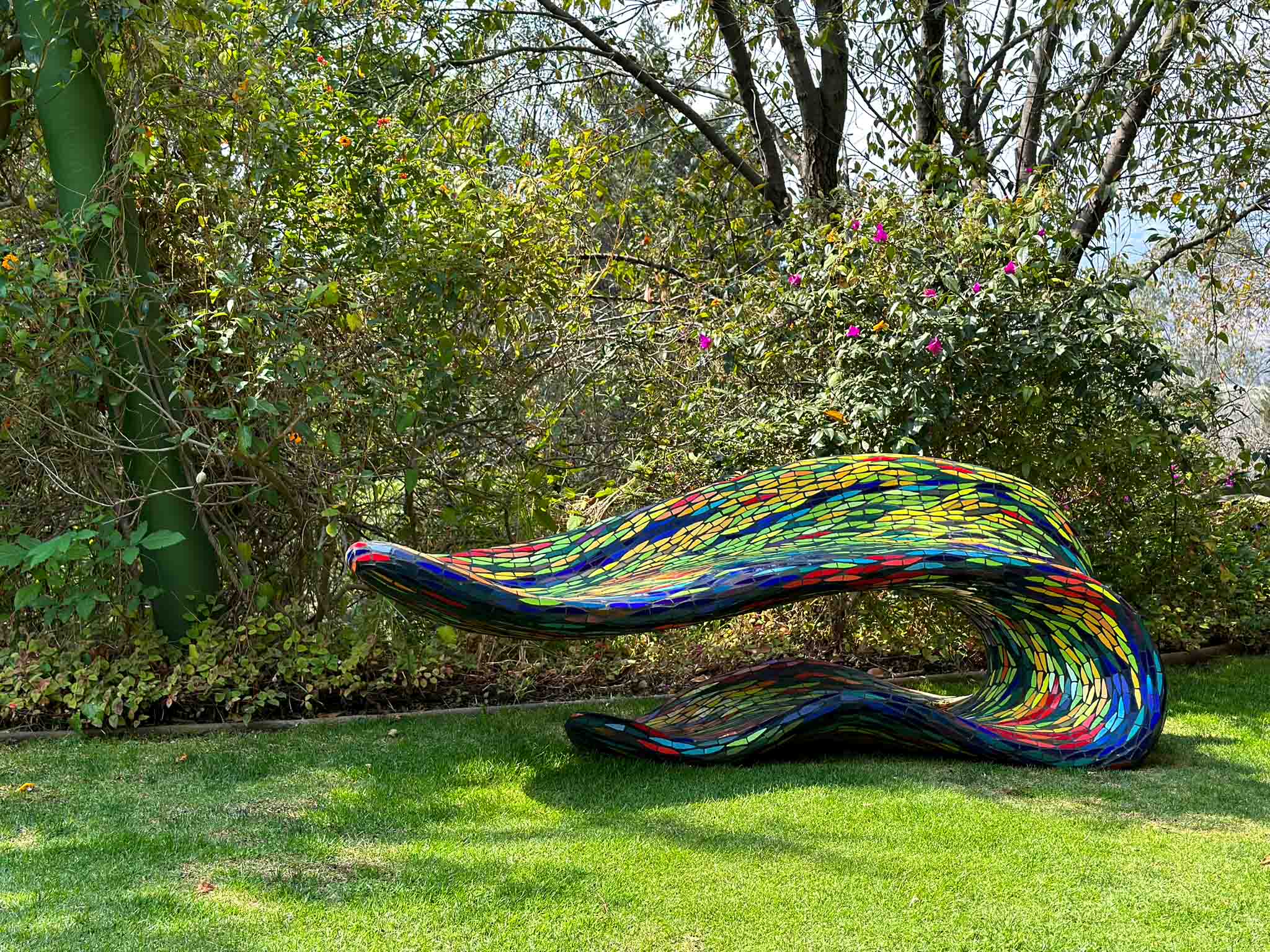 Colorful outdoor sculpture on a grassy lawn at Parque Quetzalcoatl