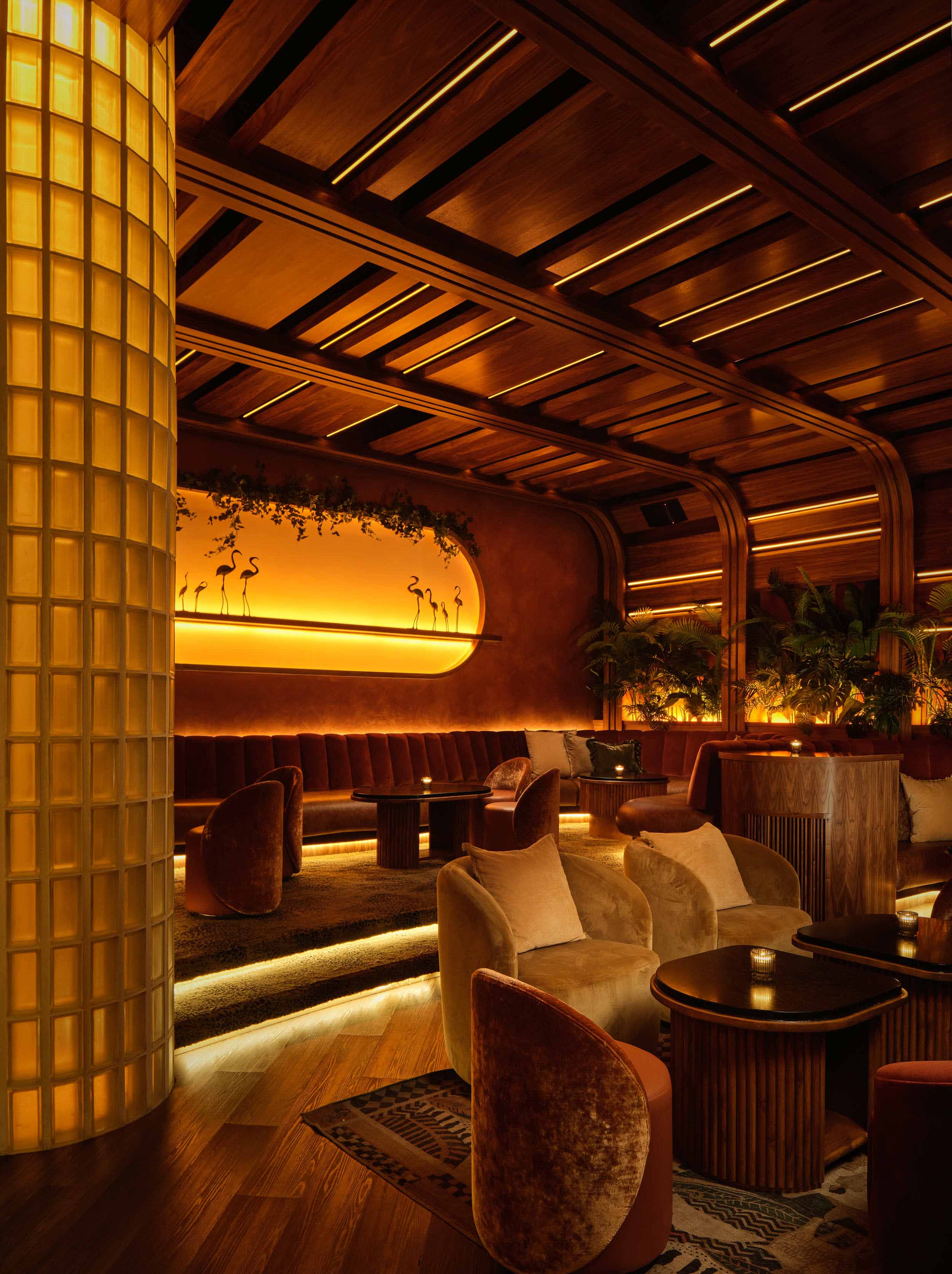 view with lit up LED floors and warm lighting throughout bar