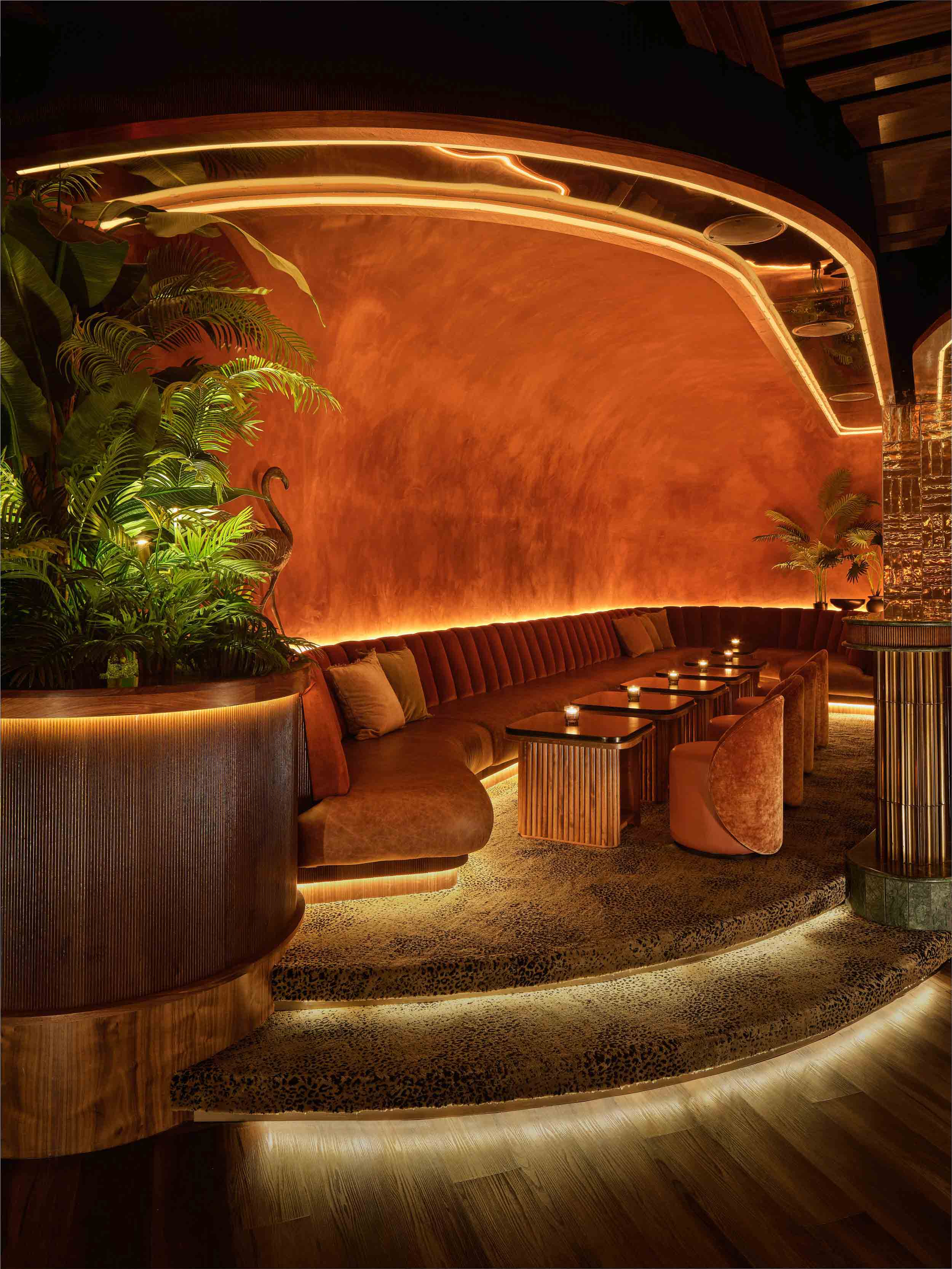 elevated seating of table with cushioned bench and velvet chairs